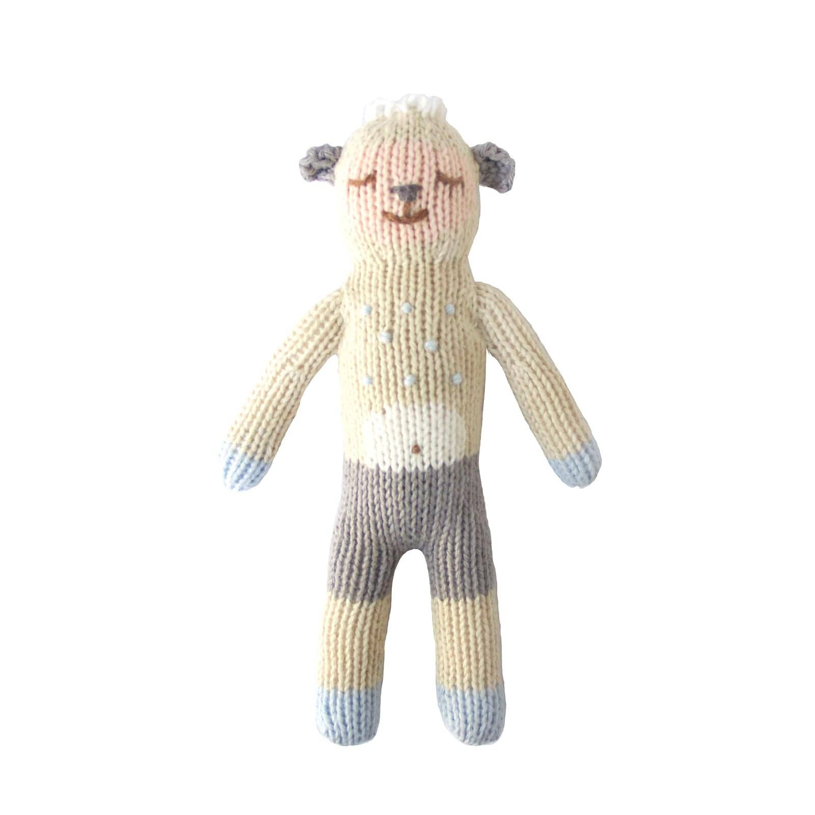 Knitted lamb rattle with a smiling face on a white background