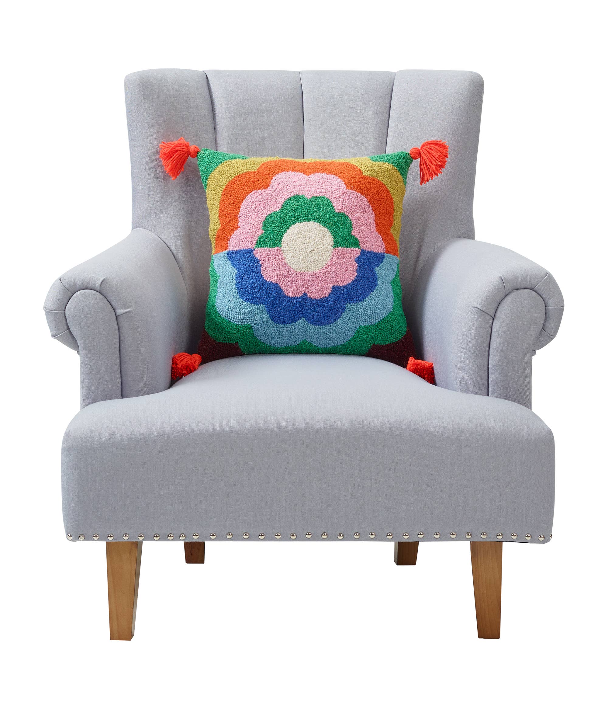 Gray armchair with a colorful floral-patterned pillow on a white background