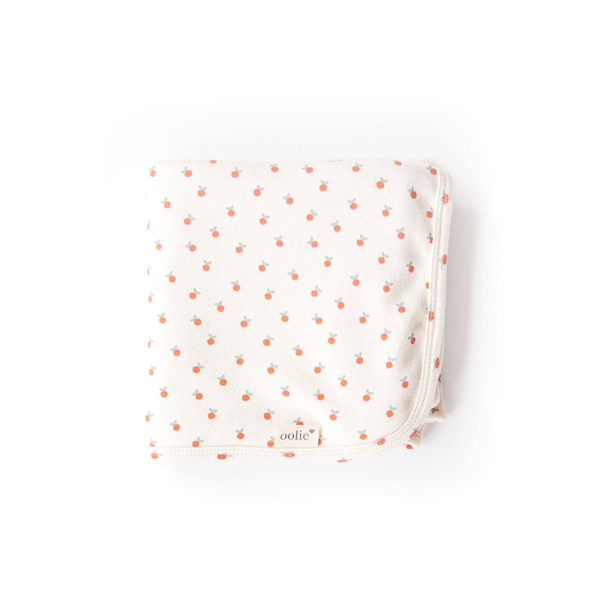 Folded fabric with small orange dots on a white background