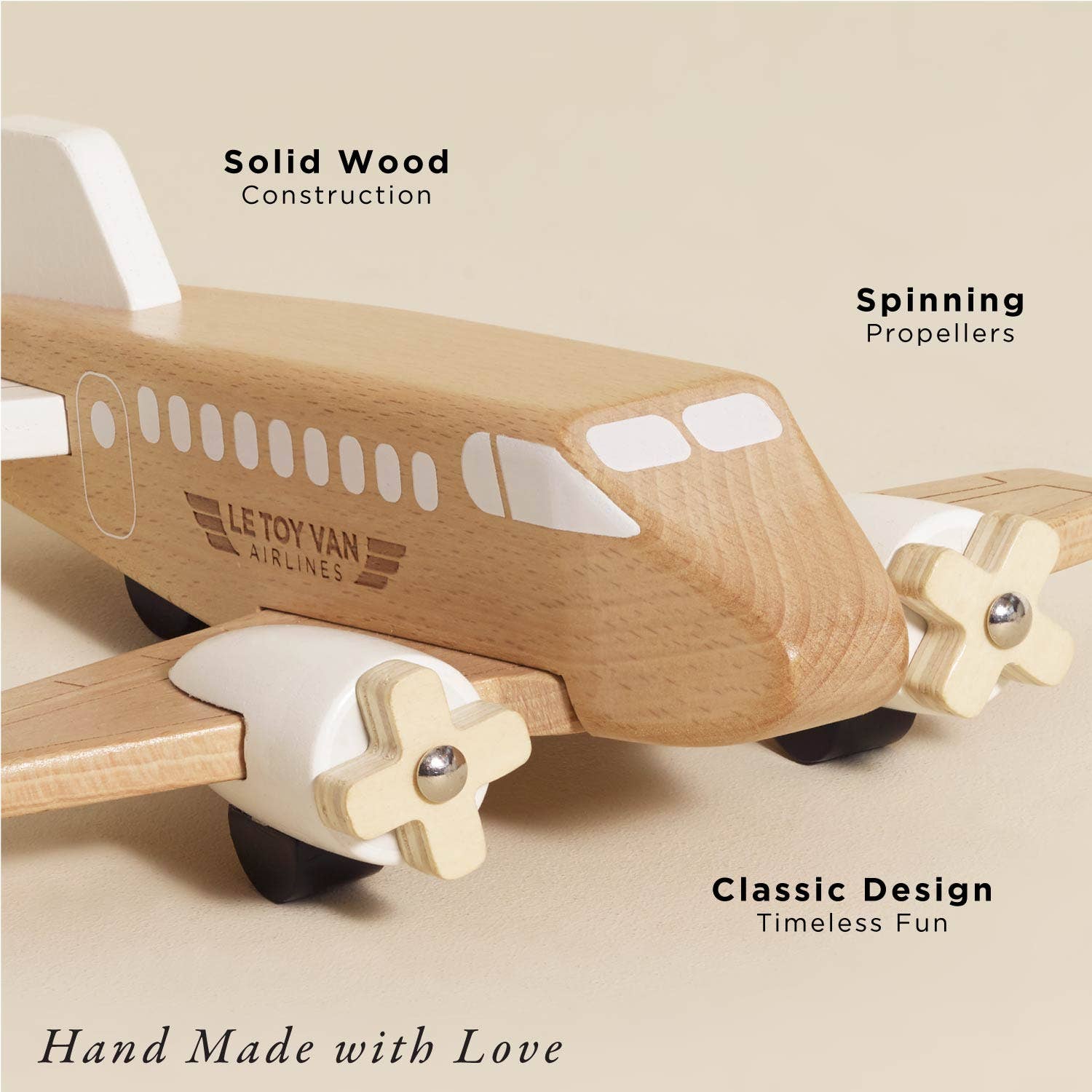 Wooden toy airplane with spinning propellers on a beige background