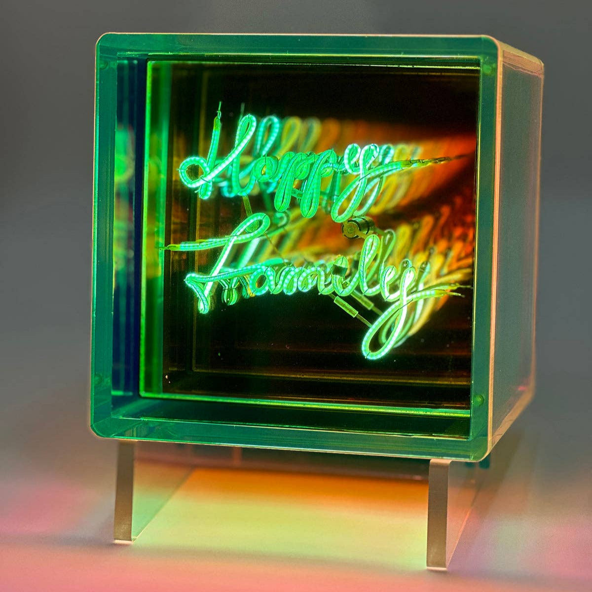 Neon sign with 'Happy Family' text inside a green block on a dark background