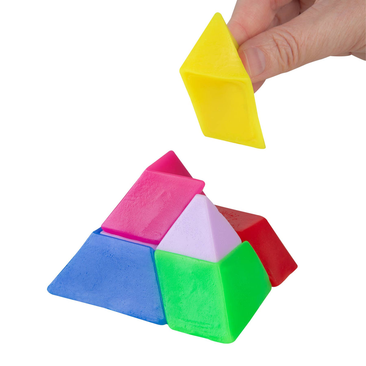 Colorful geometric pyramid-shaped blocks with a hand holding one above them on a white background