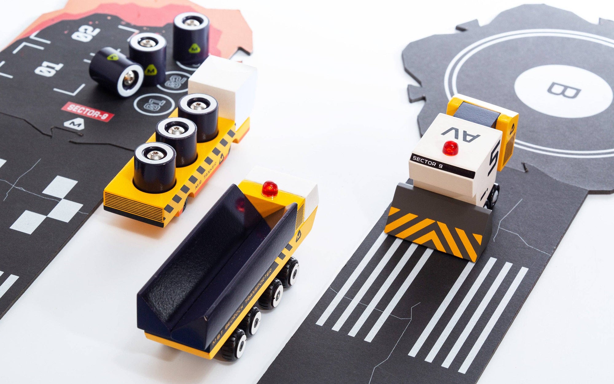 Toy cars on a road mat with traffic lights and markings