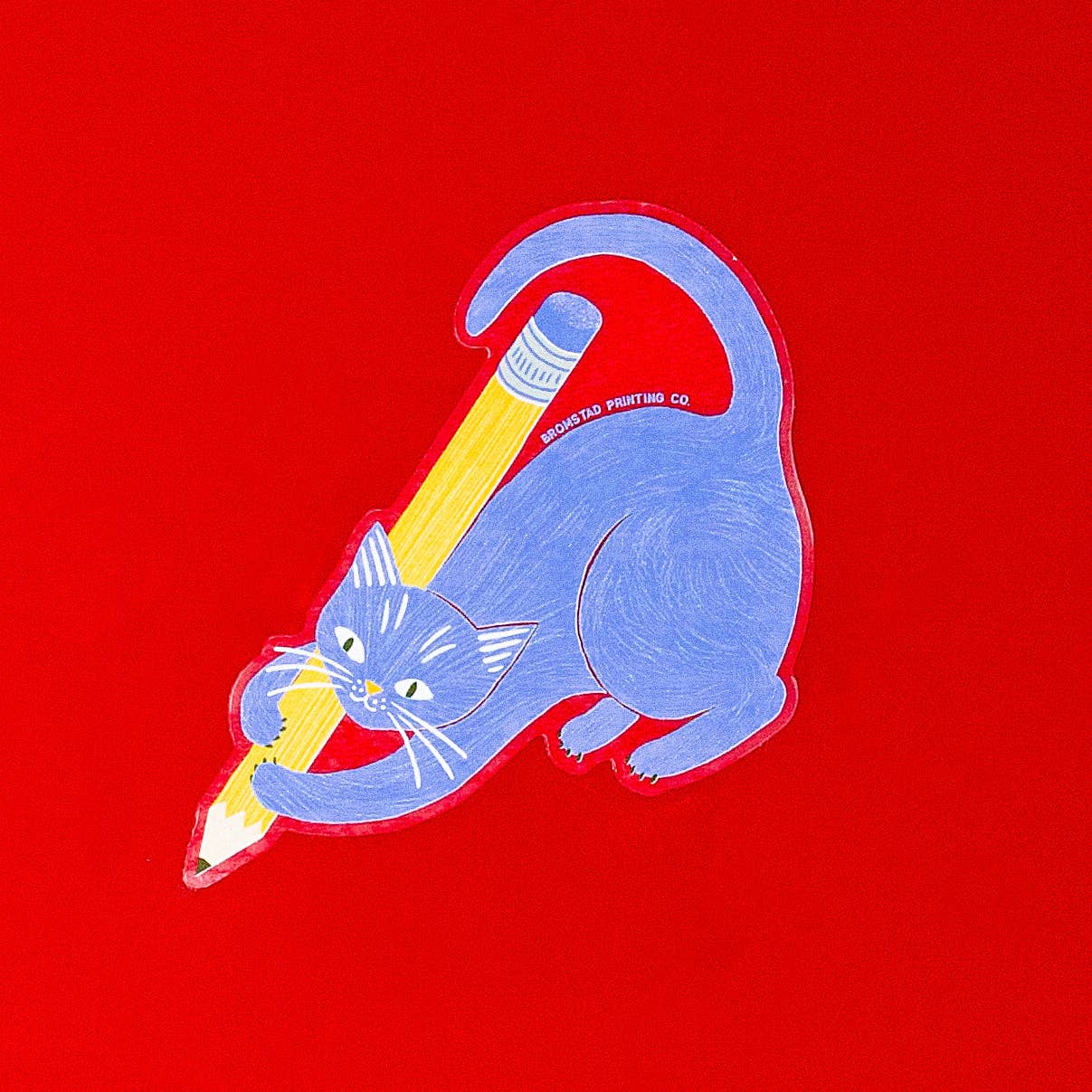 Illustration of a blue cat holding a yellow pencil on a red background