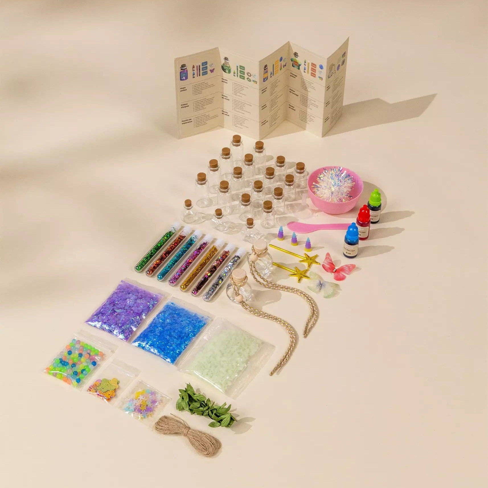 Assorted craft supplies including beads, ribbons, and a map on a beige background