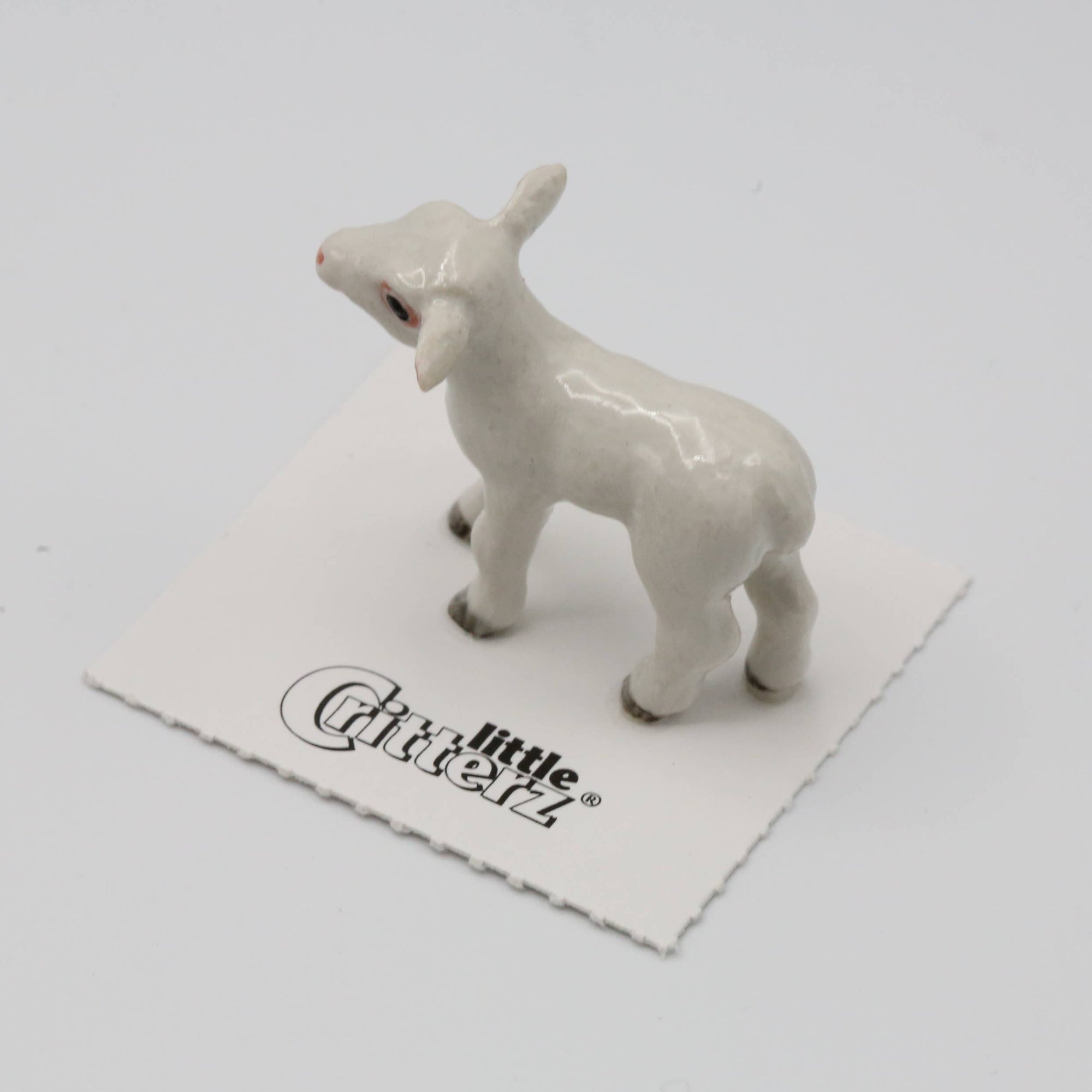White ceramic lamb figurine on a white background with 'Little Critterz' branding.