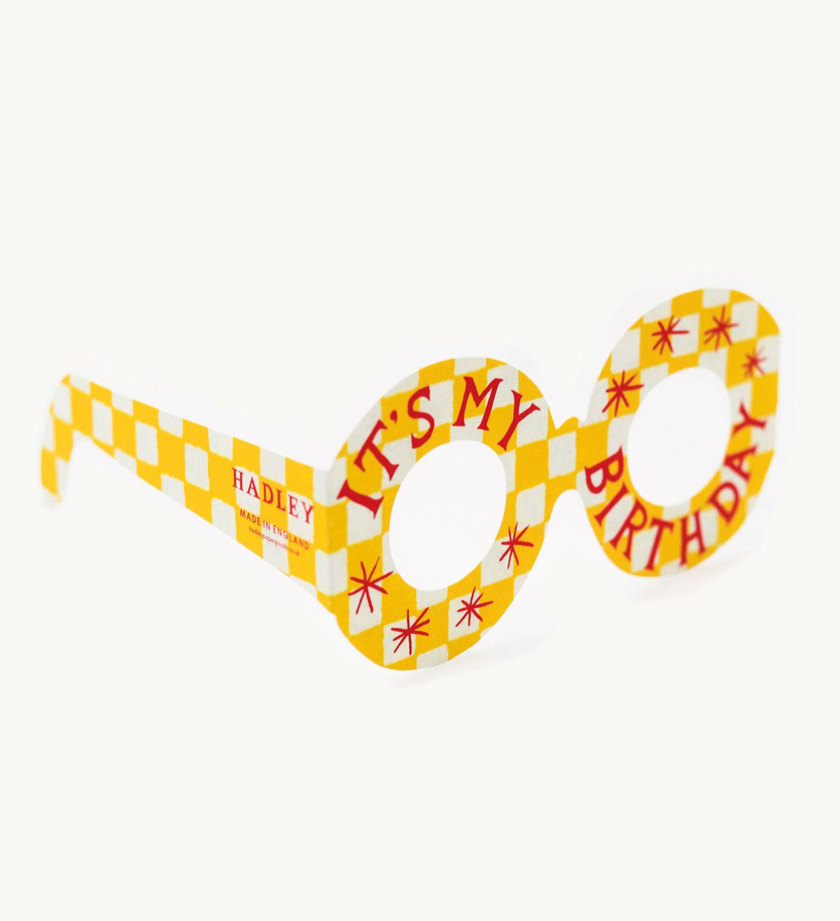 Birthday-themed novelty glasses with checkered design and text on a white background