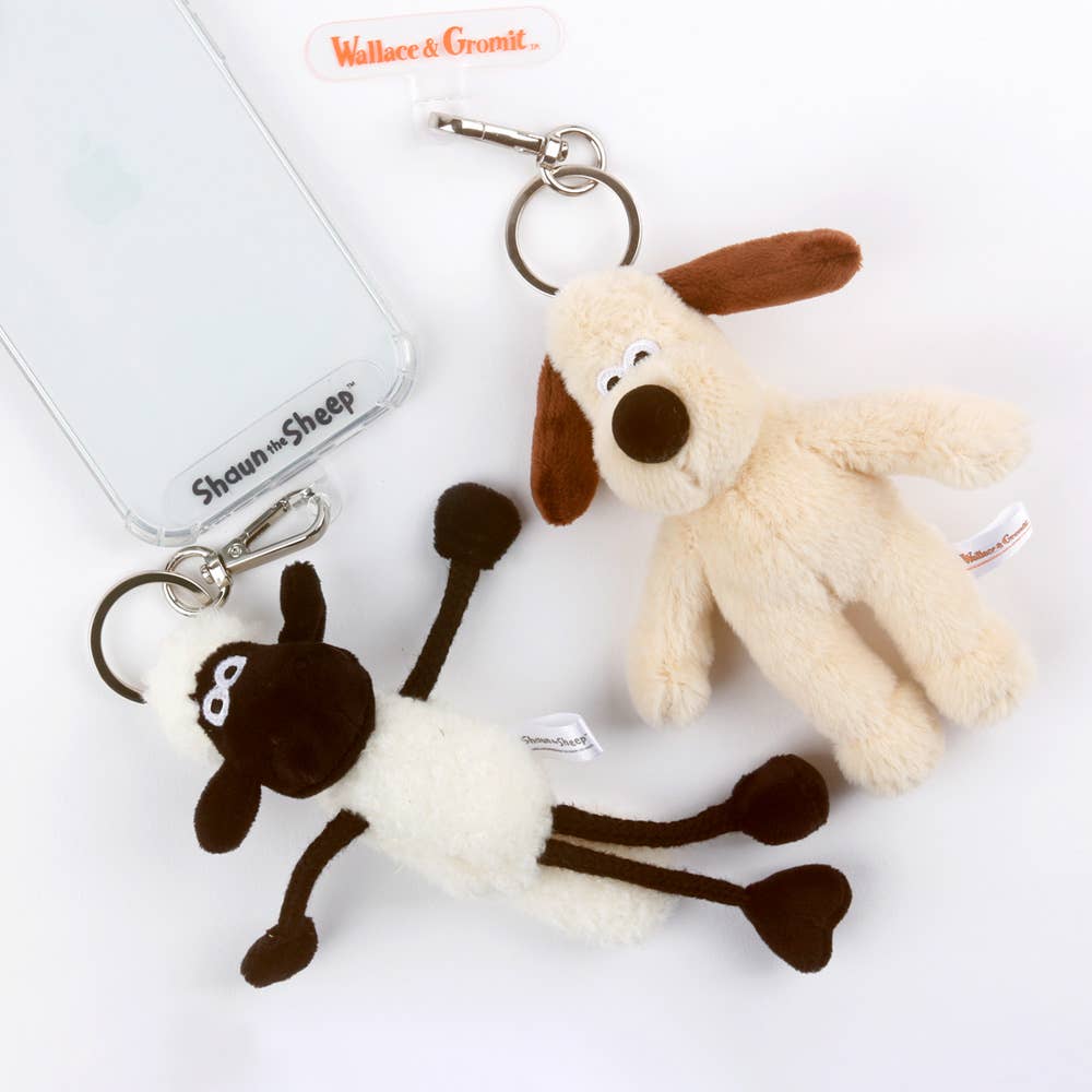Two plush keychains, one resembling a dog and the other a sheep, with 'Wallace & Gromit' branding on a white background.