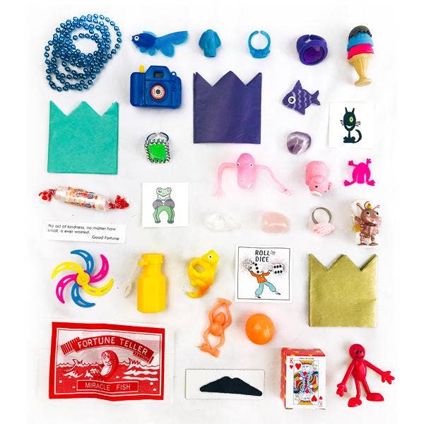 Collection of various small toys and items on a white background