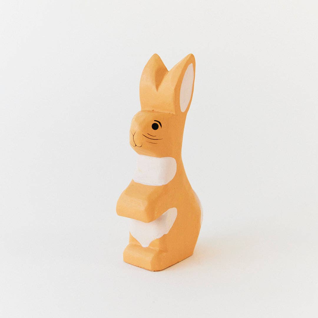 Orange rabbit-shaped object on a white background