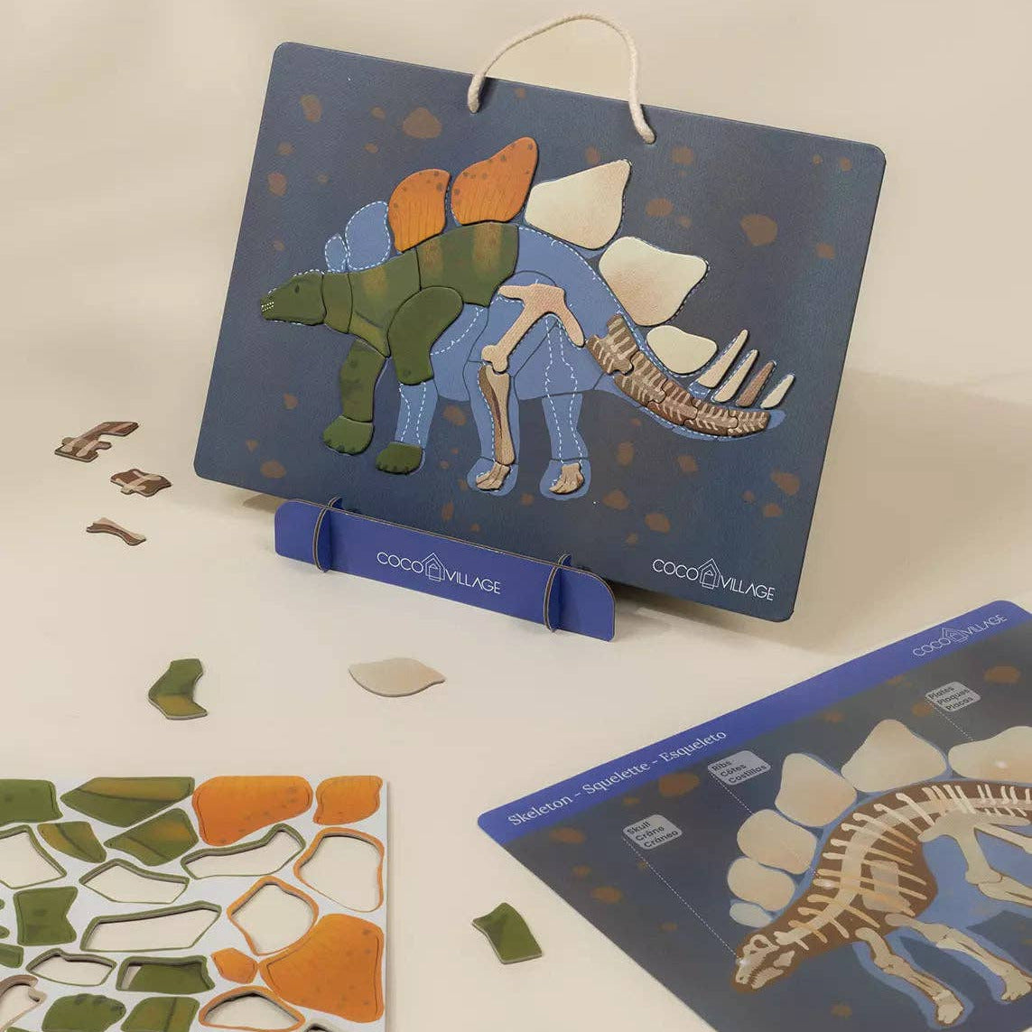 Children's dinosaur puzzle with pieces and a stand on a light background