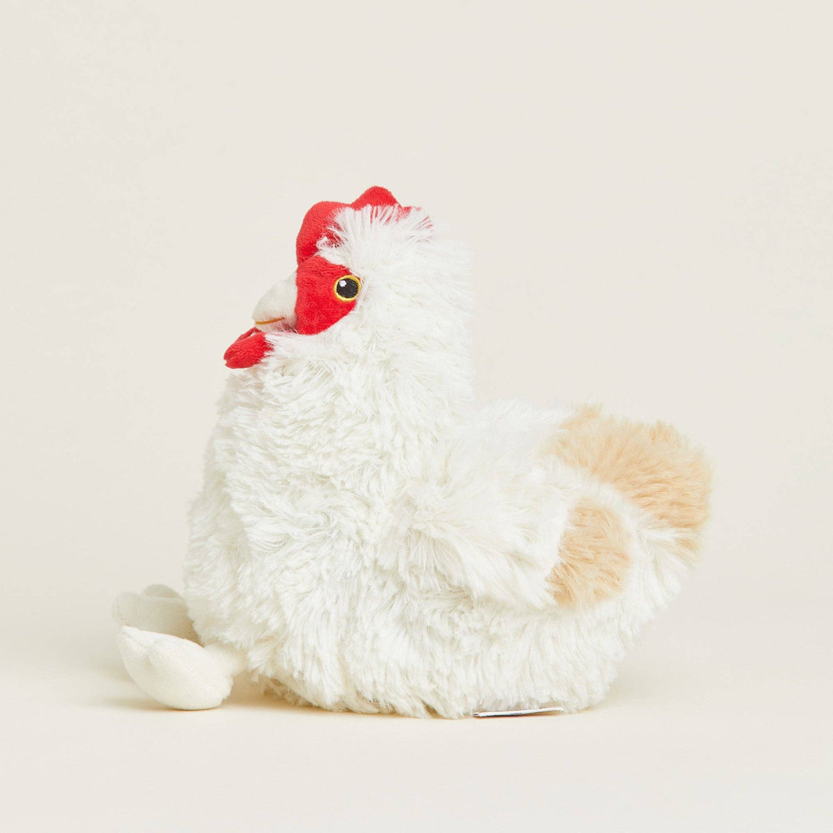Plush toy chicken with a red comb on a light beige background