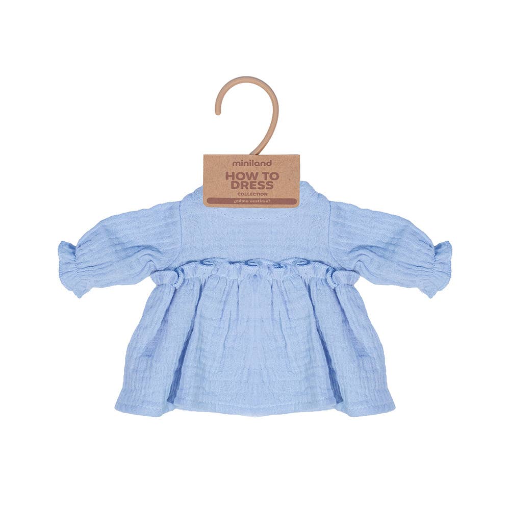 Blue doll's dress on a hanger with 'miniland' label