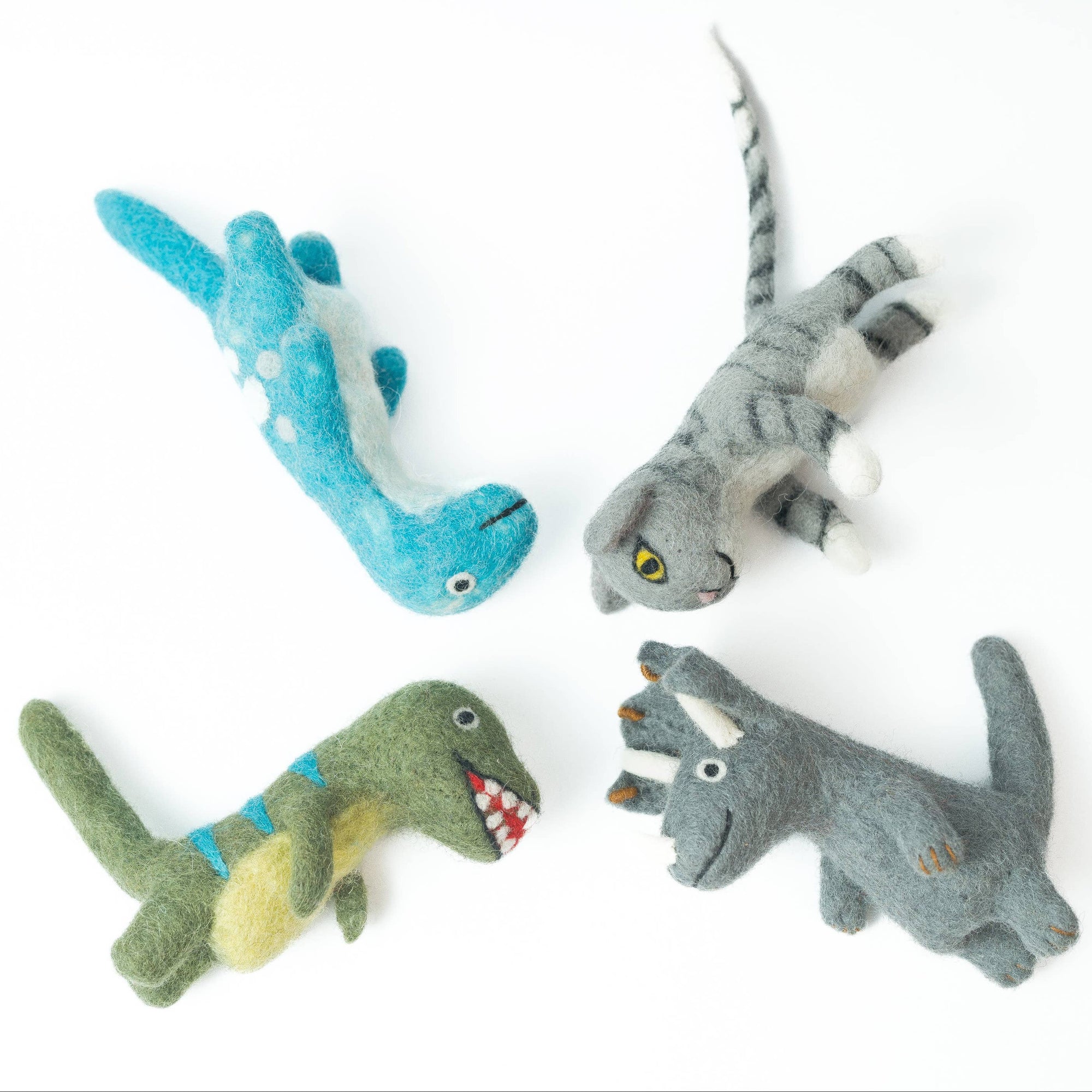 Four toy lizards in different colors on a white background
