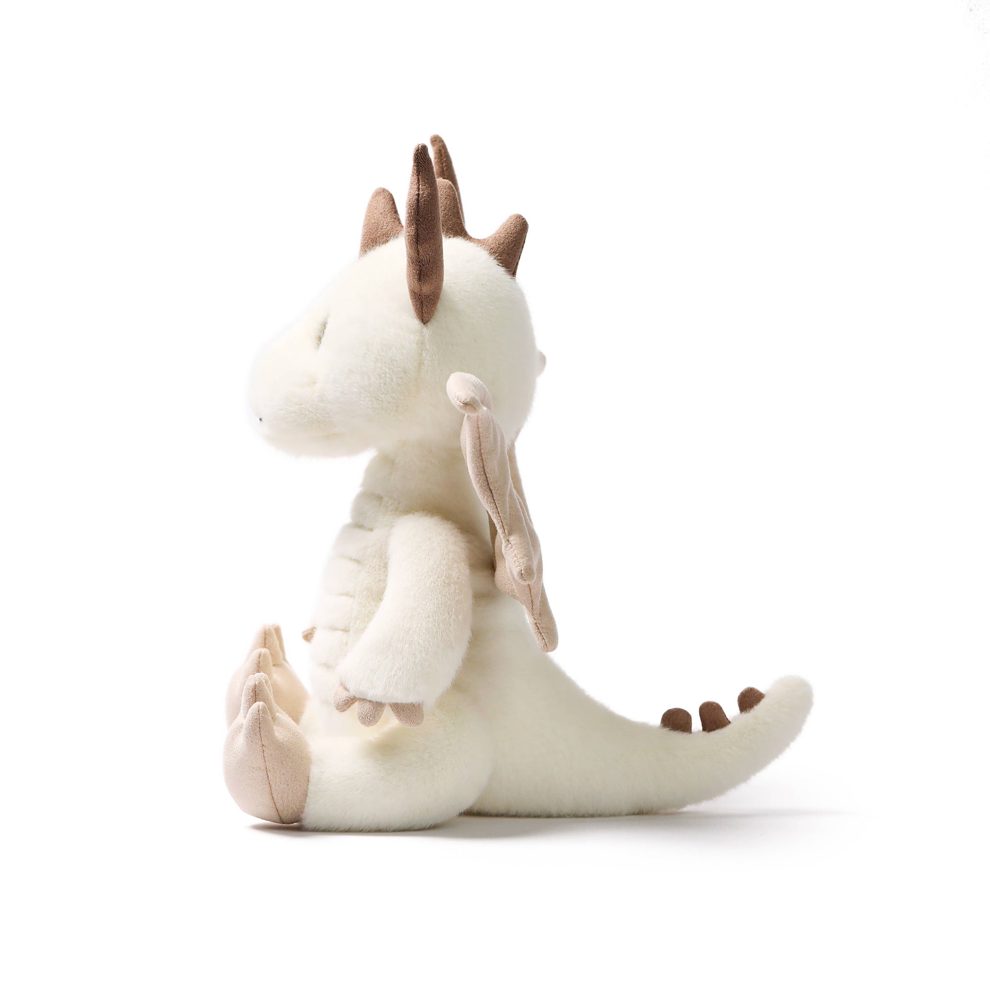 White plush dragon toy with brown accents on a white background