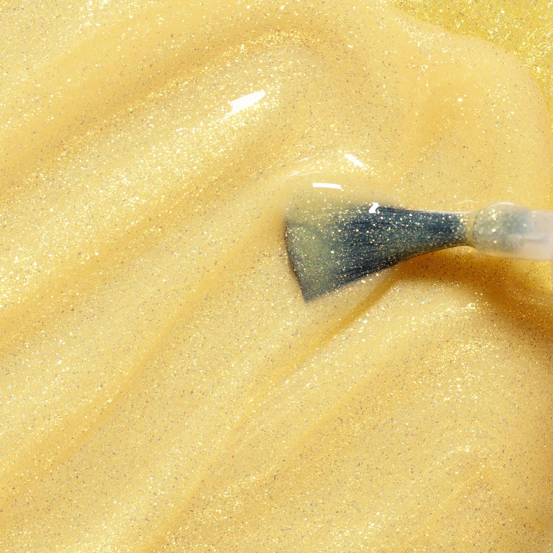 Close-up of a spoon with a creamy yellow substance on a matching background