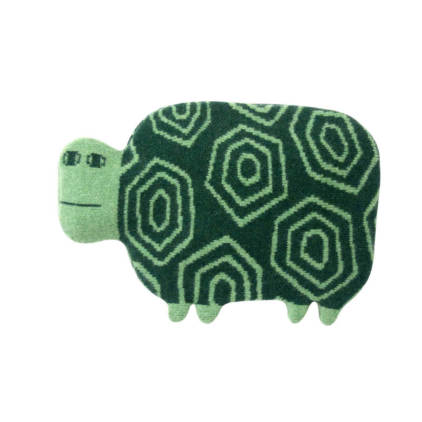 Green turtle-shaped rug with geometric pattern on a white background