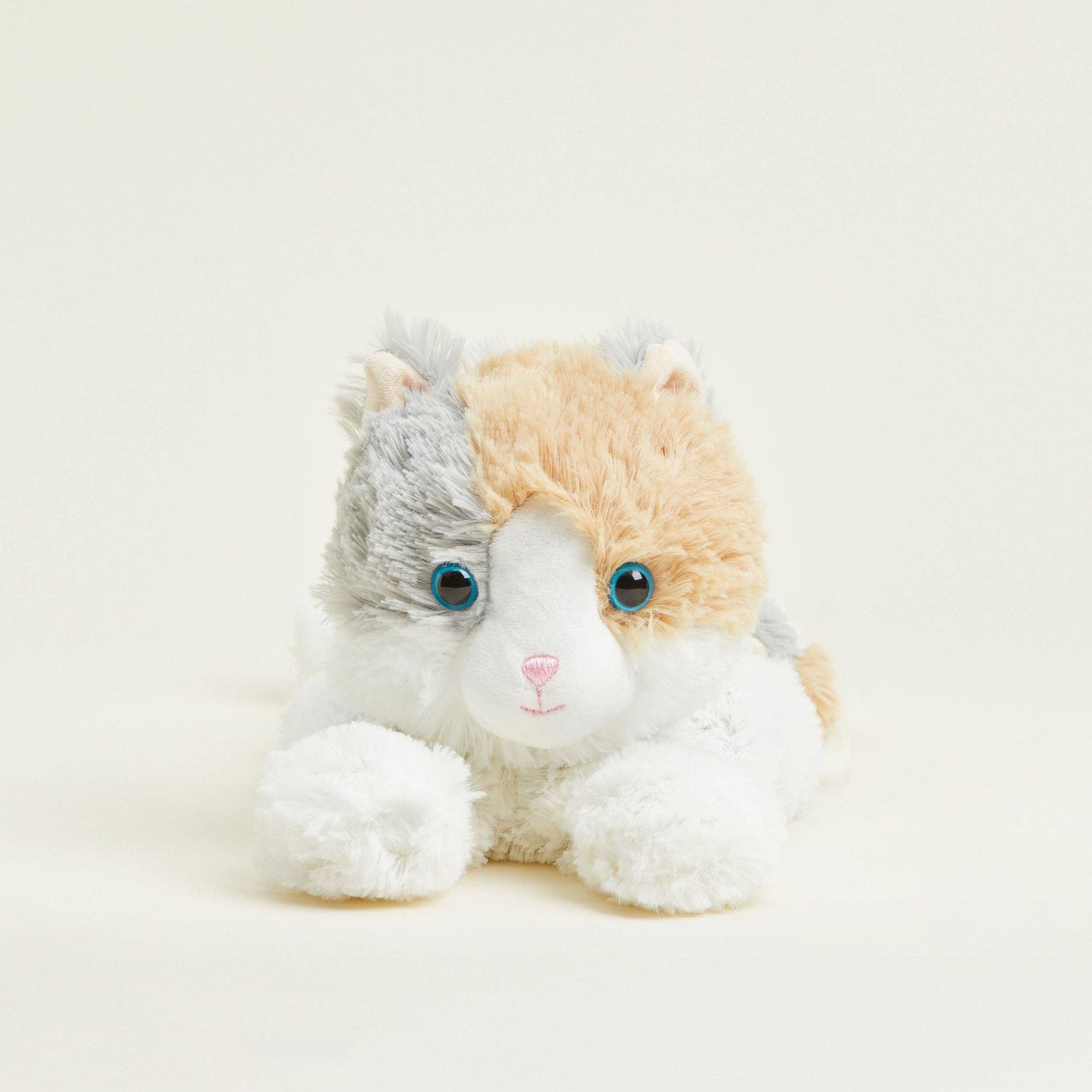Plush toy resembling a cat with a white face on a light background