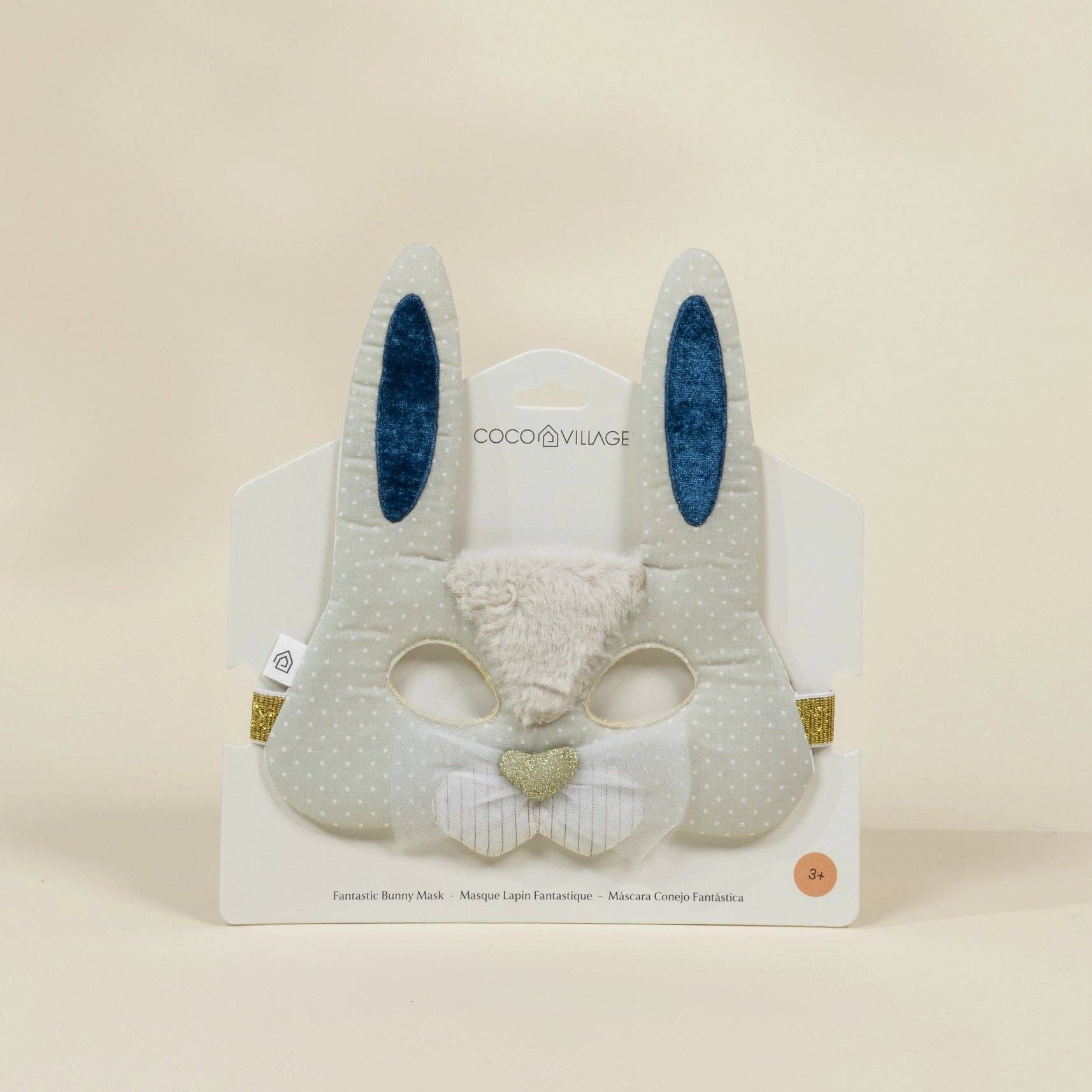 Plush bunny toy with blue ears on a beige background