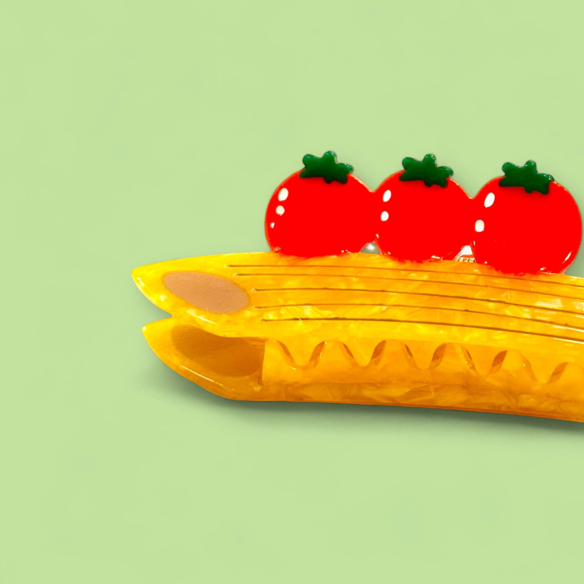 Yellow corn on a green background with red tomatoes above it