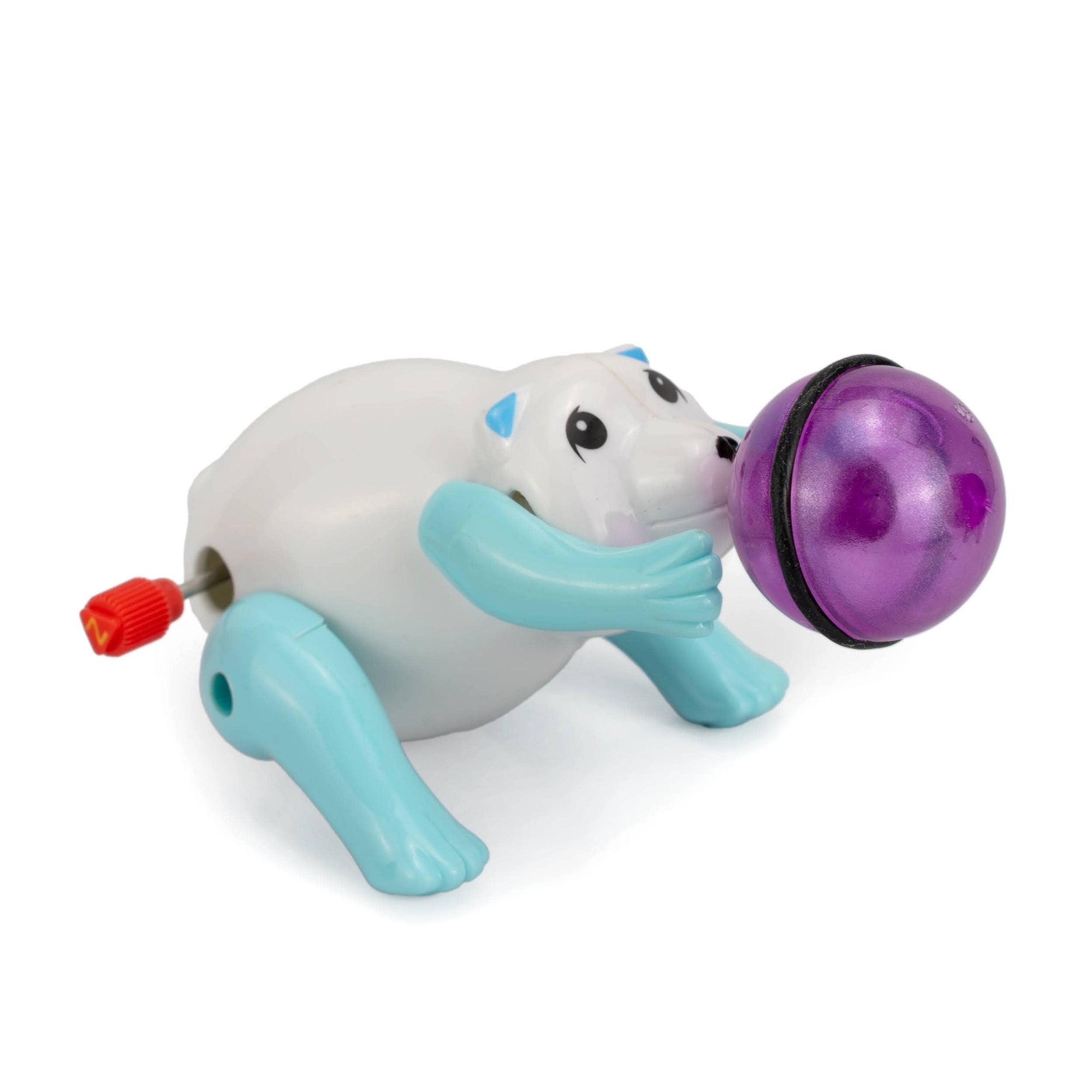Toy figure of a polar bear with a purple ball on a white background