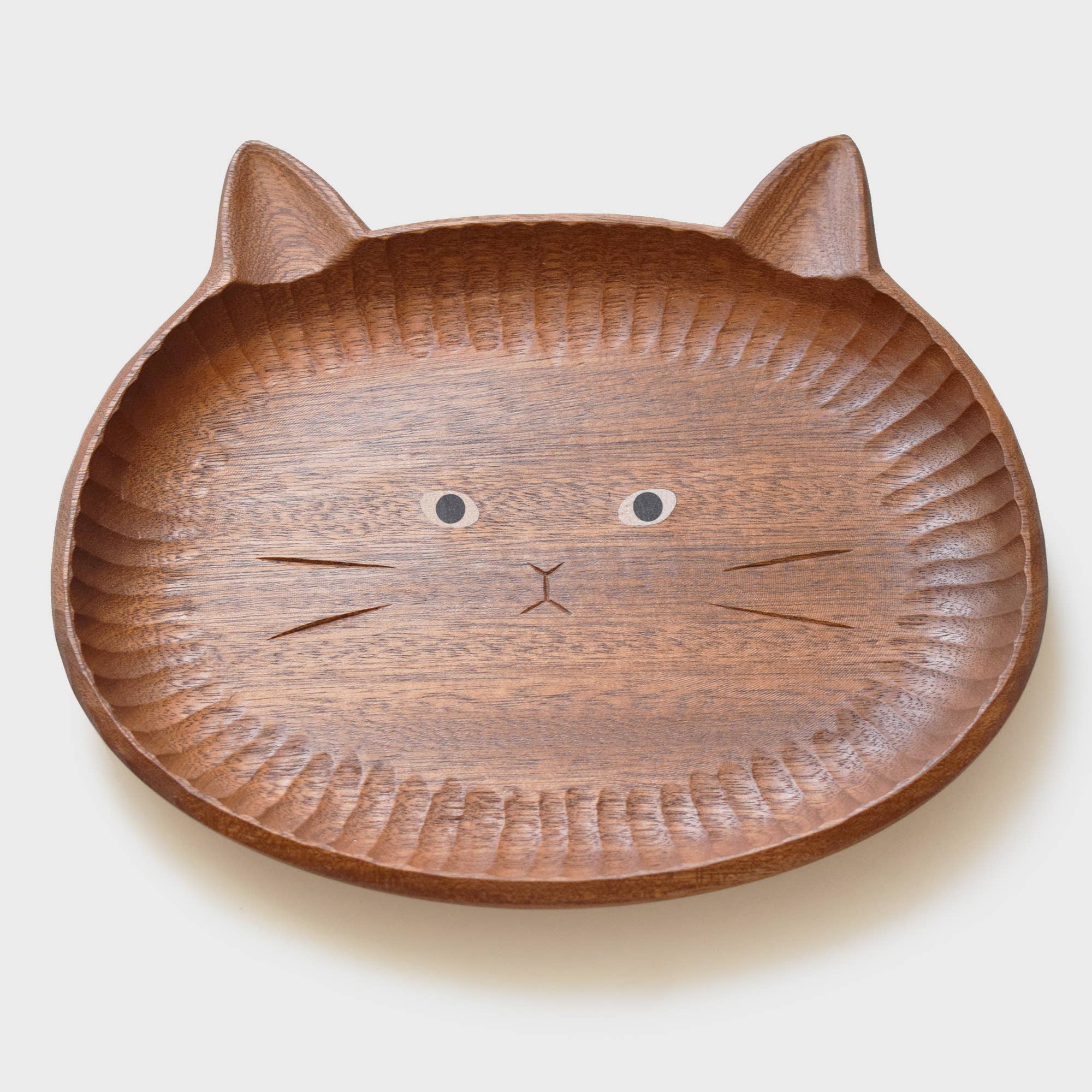 Wooden plate shaped like a cat face on a white background