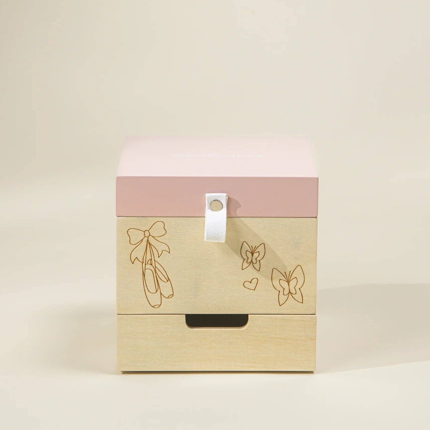 Wooden box with pink top and ballet-themed designs on a beige background