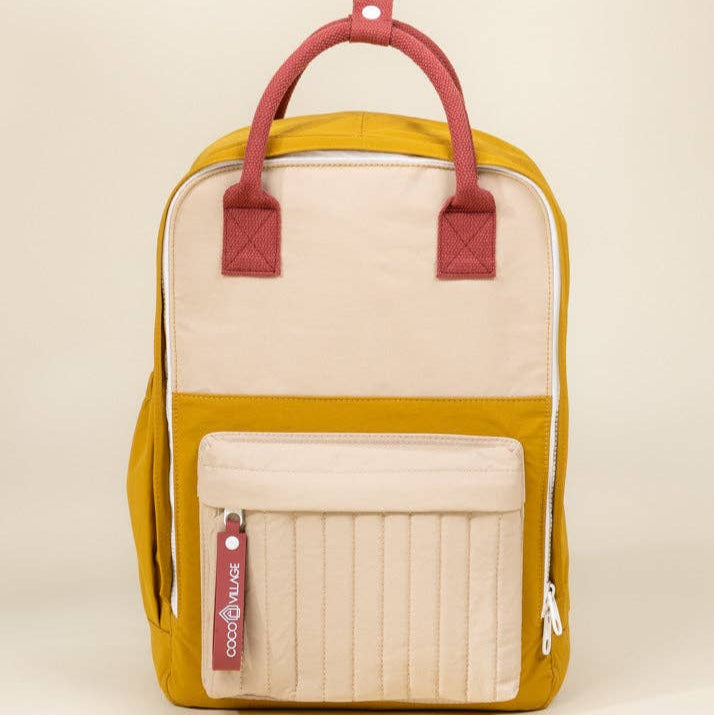 Backpack with red straps and beige accents on a beige background