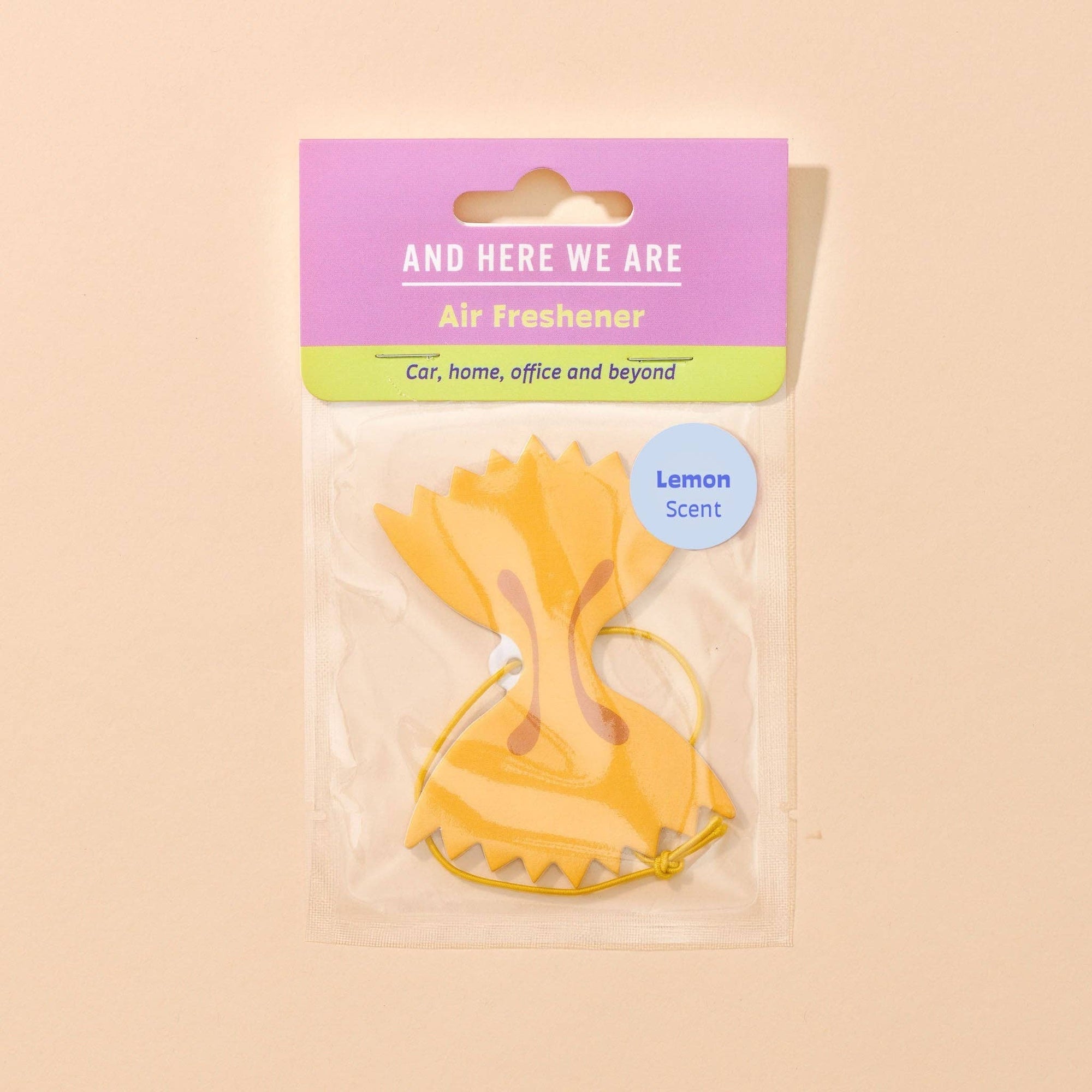 Yellow air freshener with packaging on a beige background