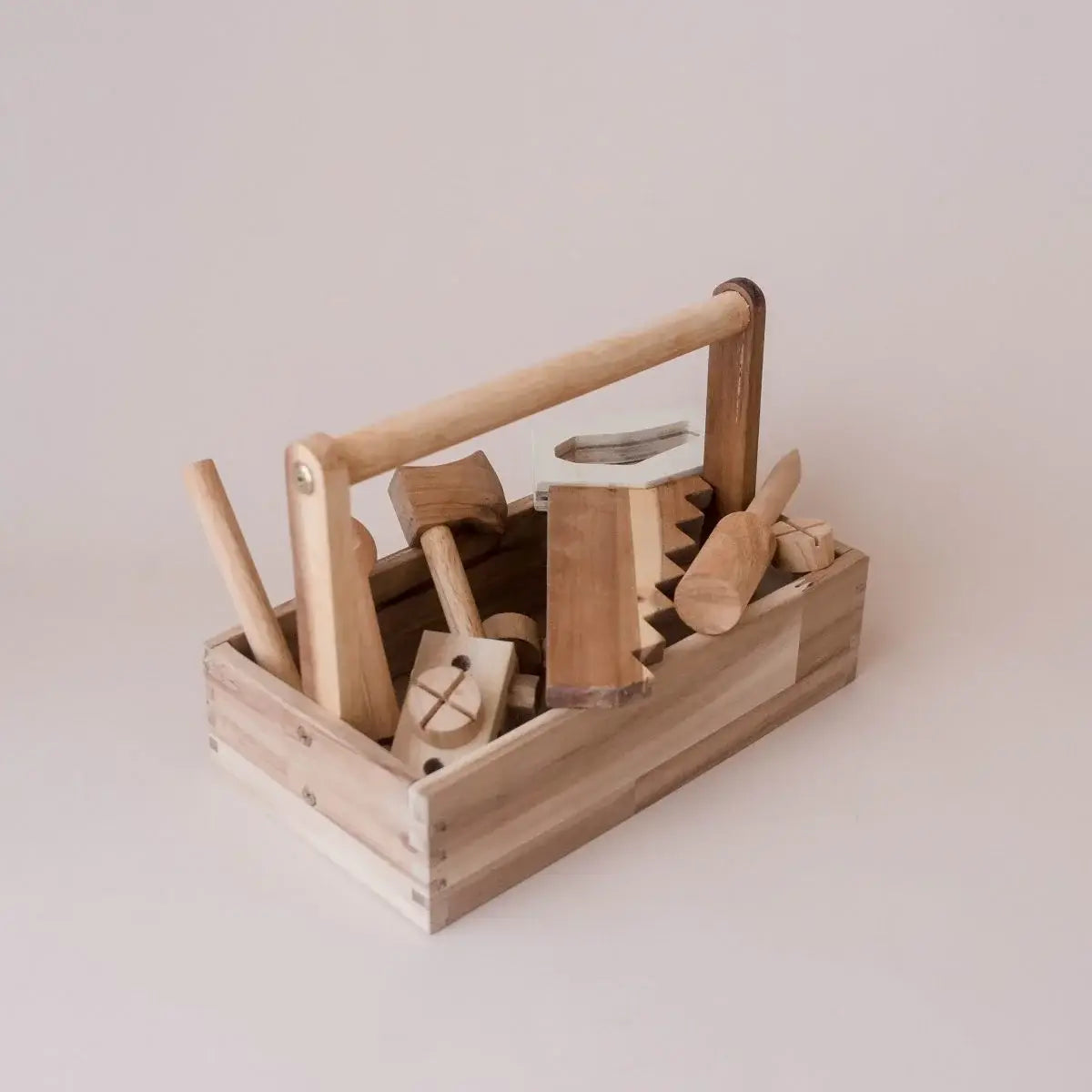 Wooden tool set in a box on a light background