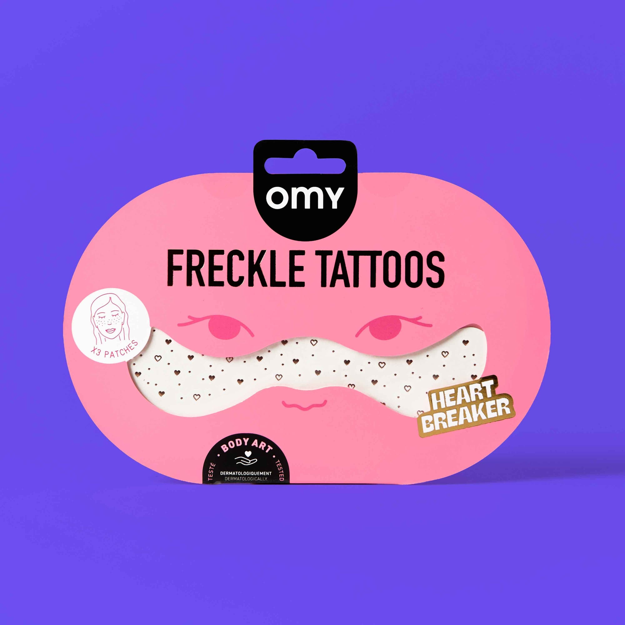 Packaging of freckle tattoos with 'omv' branding on a purple background