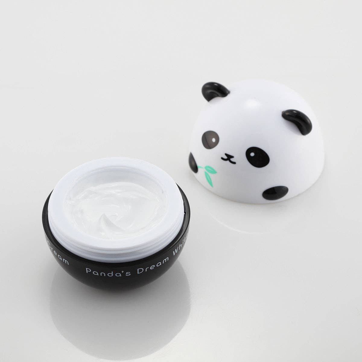 Panda-themed skincare product with a white lid on a light gray background