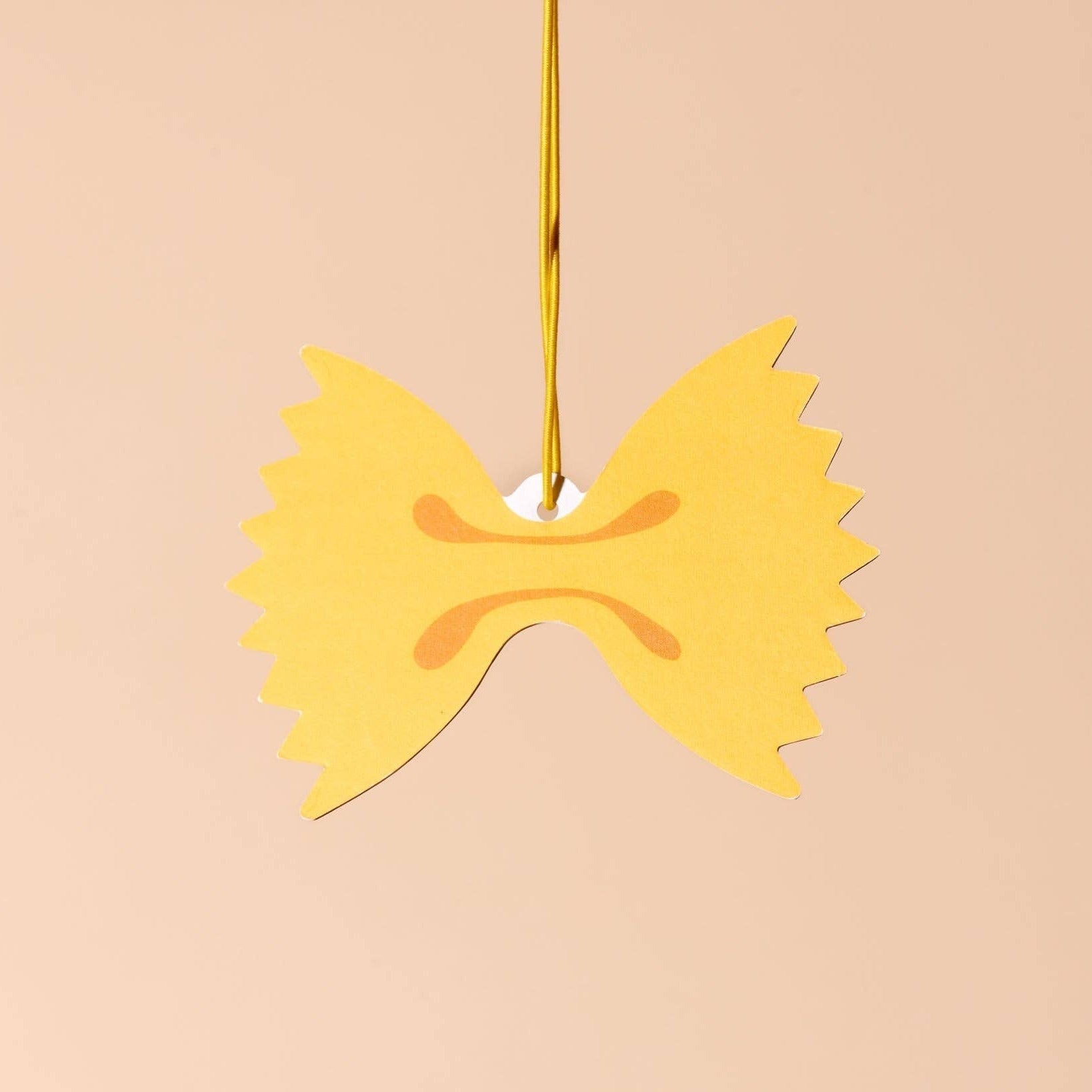 Bow tie pasta with olive oil drizzle on a beige background