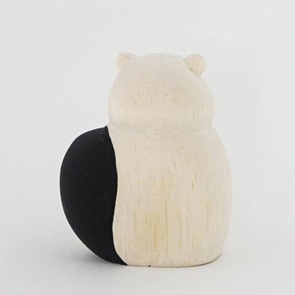 Two-toned black and white spherical objects on a light gray background