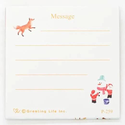 Notepad with Santa Claus and reindeer illustration and 'Greeting Life Inc.' branding.