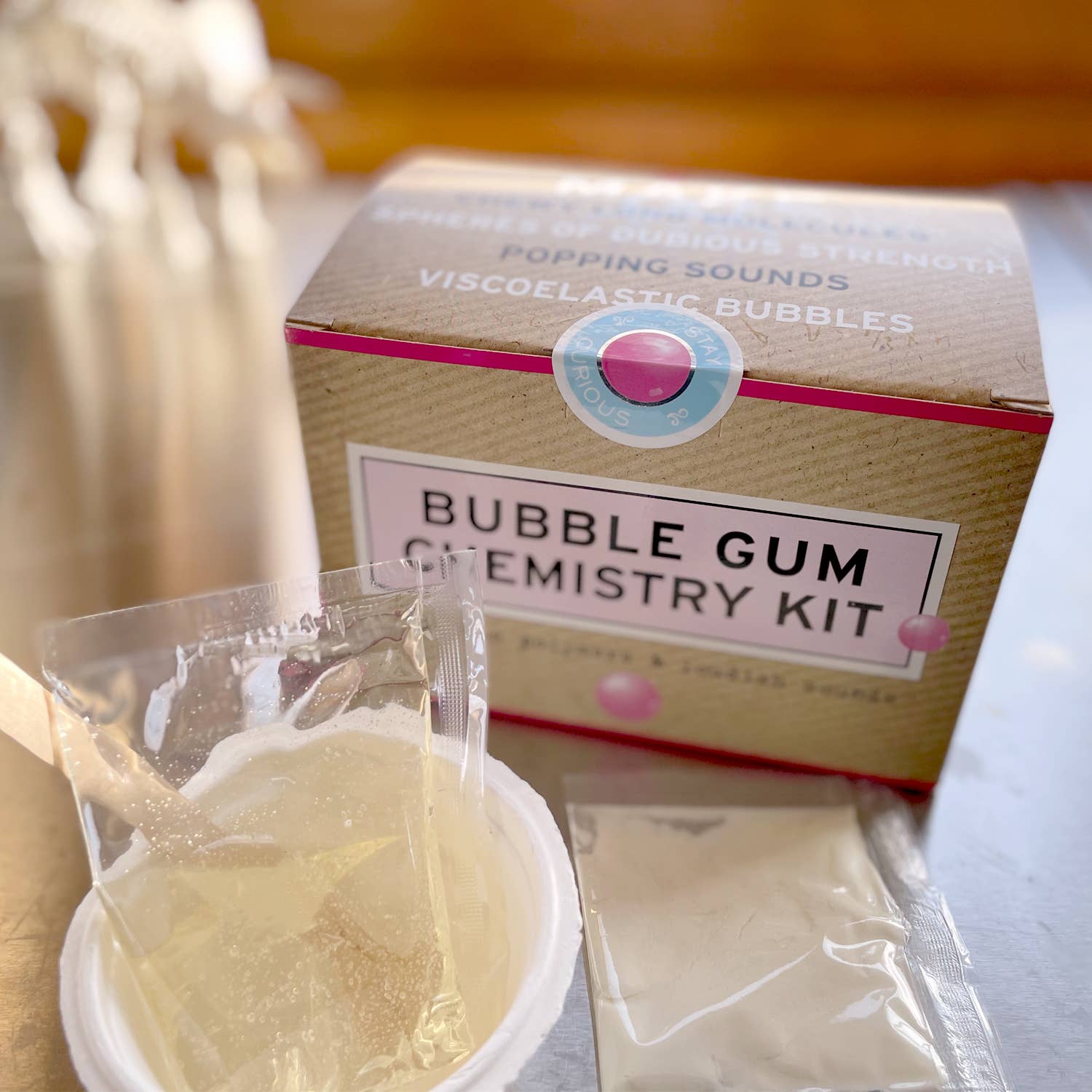 Bubble gum chemistry kit with packaging and materials on a white surface