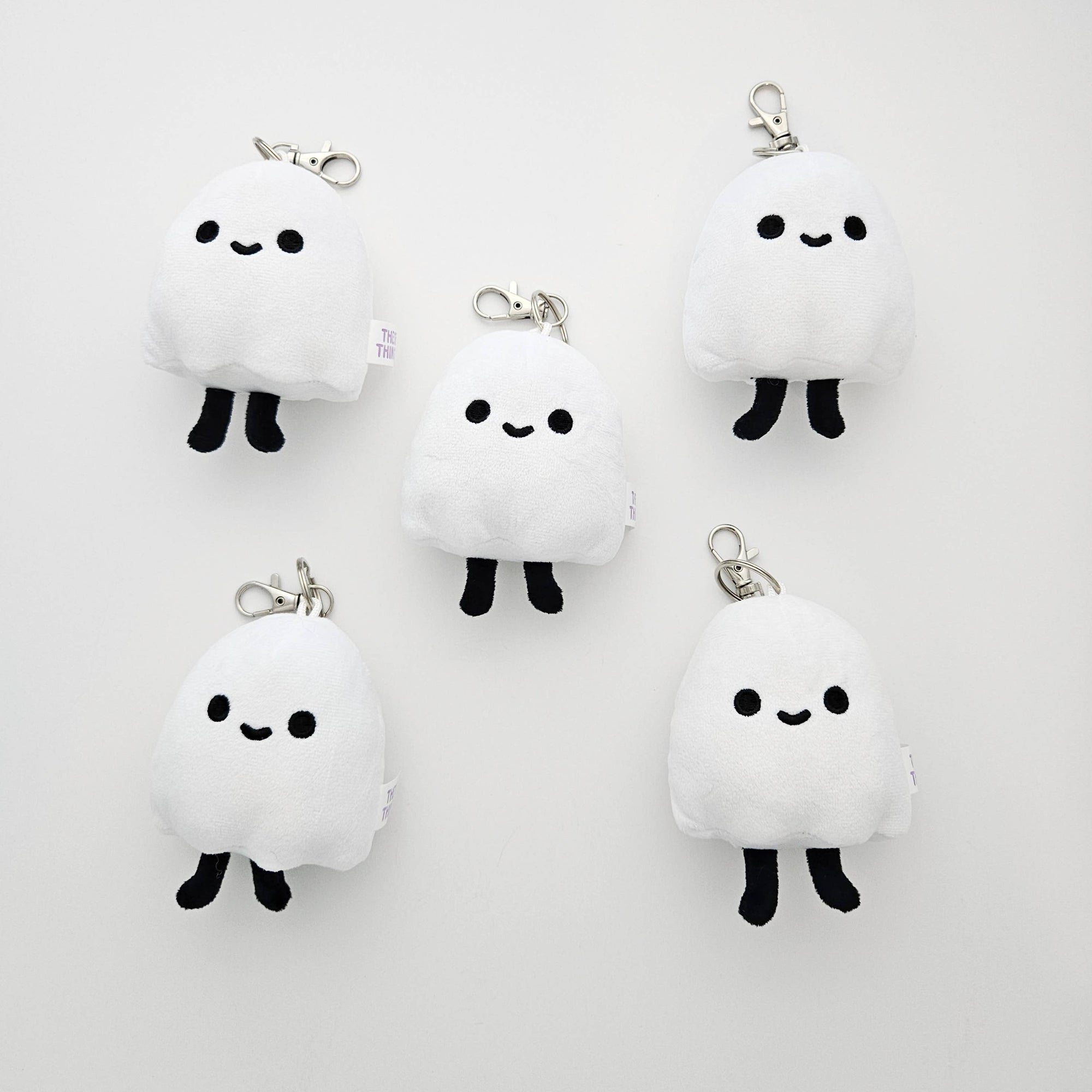 Set of plush ghost keychains on a white background