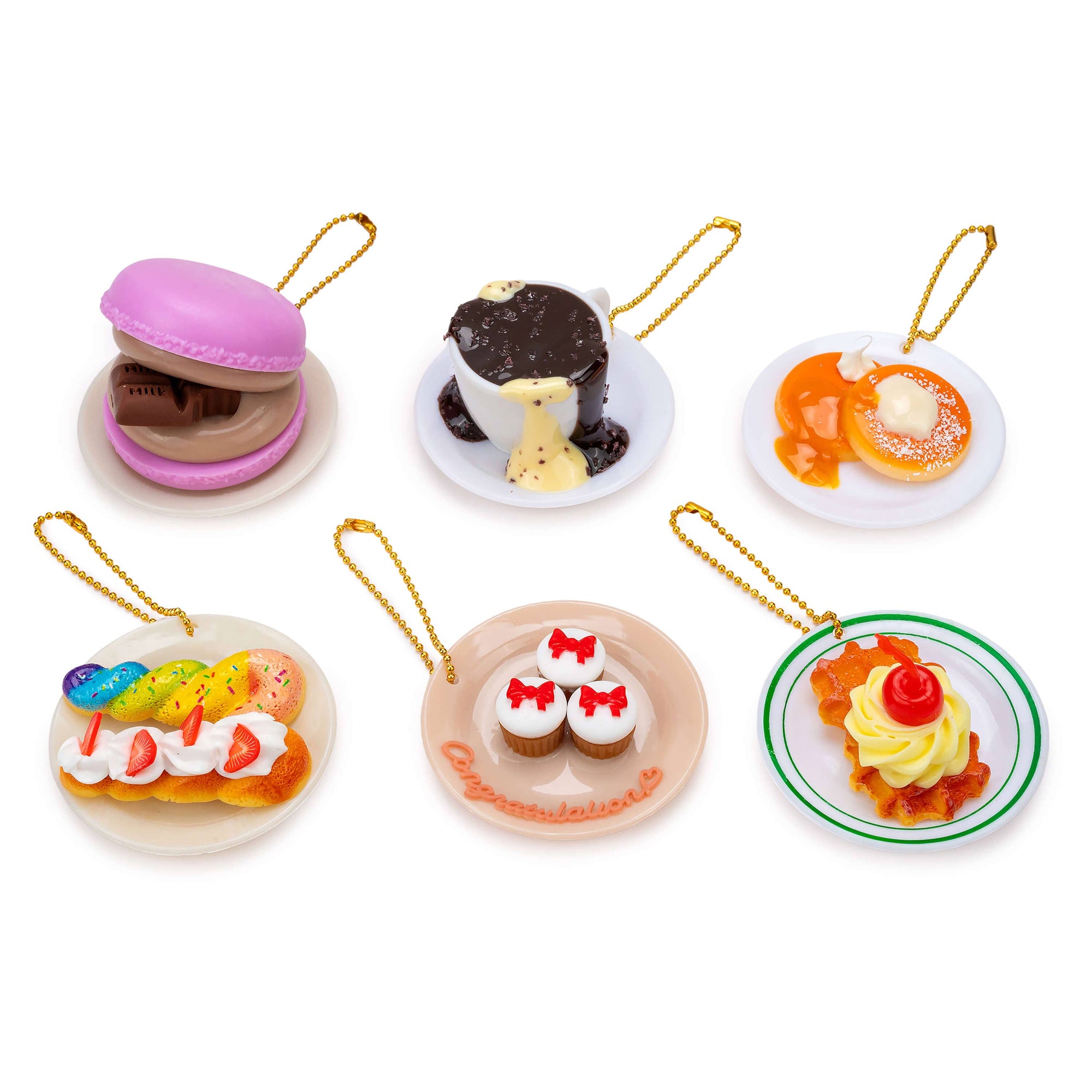 Set of miniature dessert figurines on white background