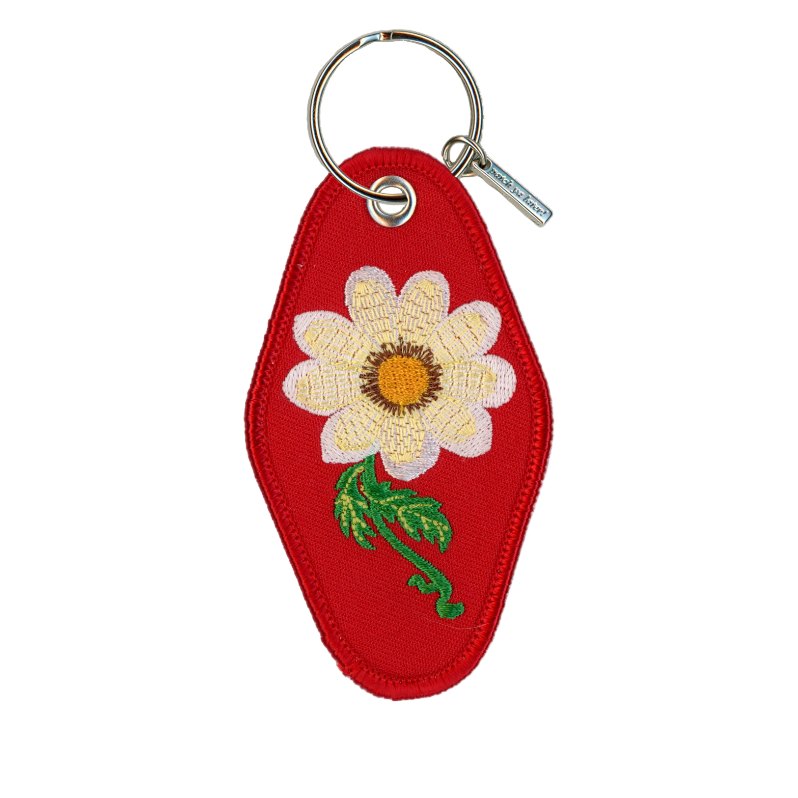 Red keychain with a white flower design on a white background