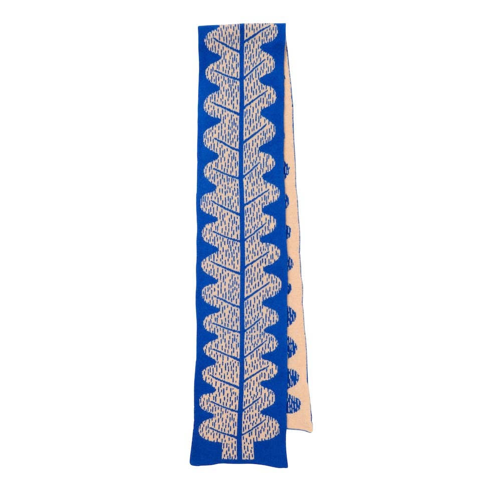 Long rectangular knit scarf with blue and beige pattern on a white background