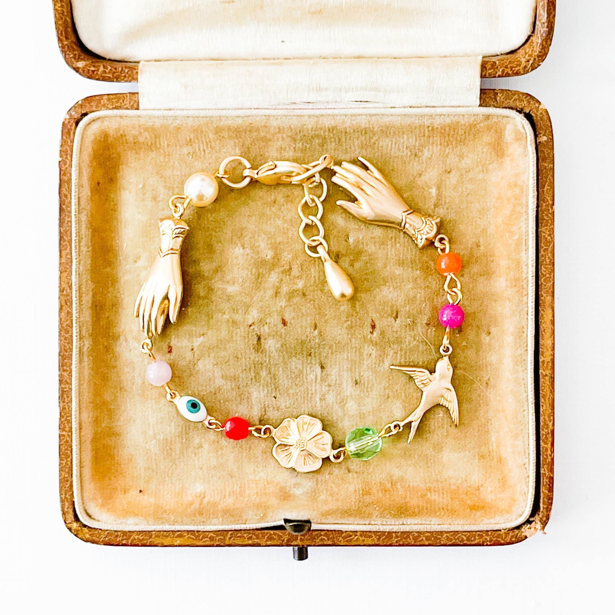 Gold bracelet with charms in a decorative box