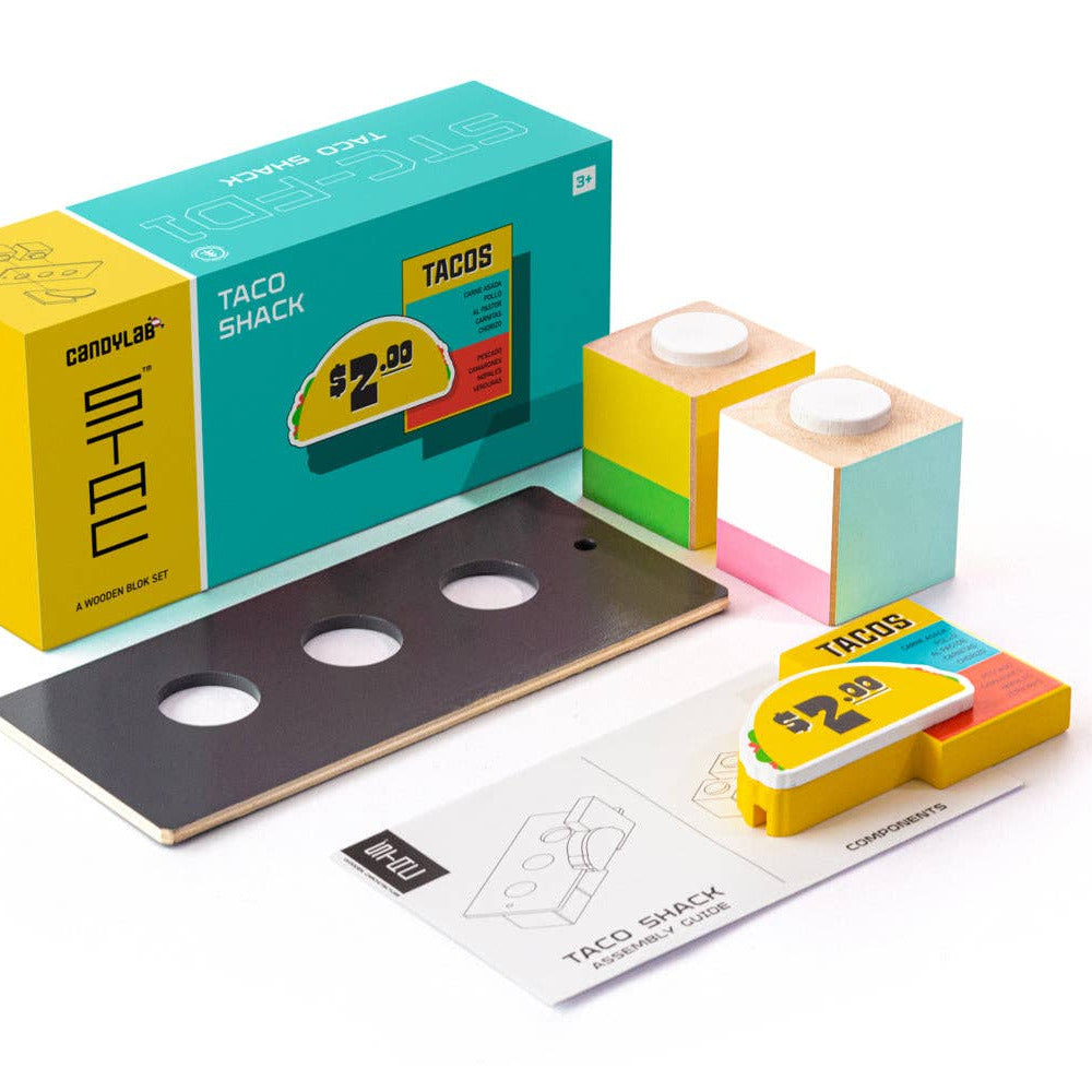 Colorful toy set with packaging labeled 'Taco Shack' on a white background