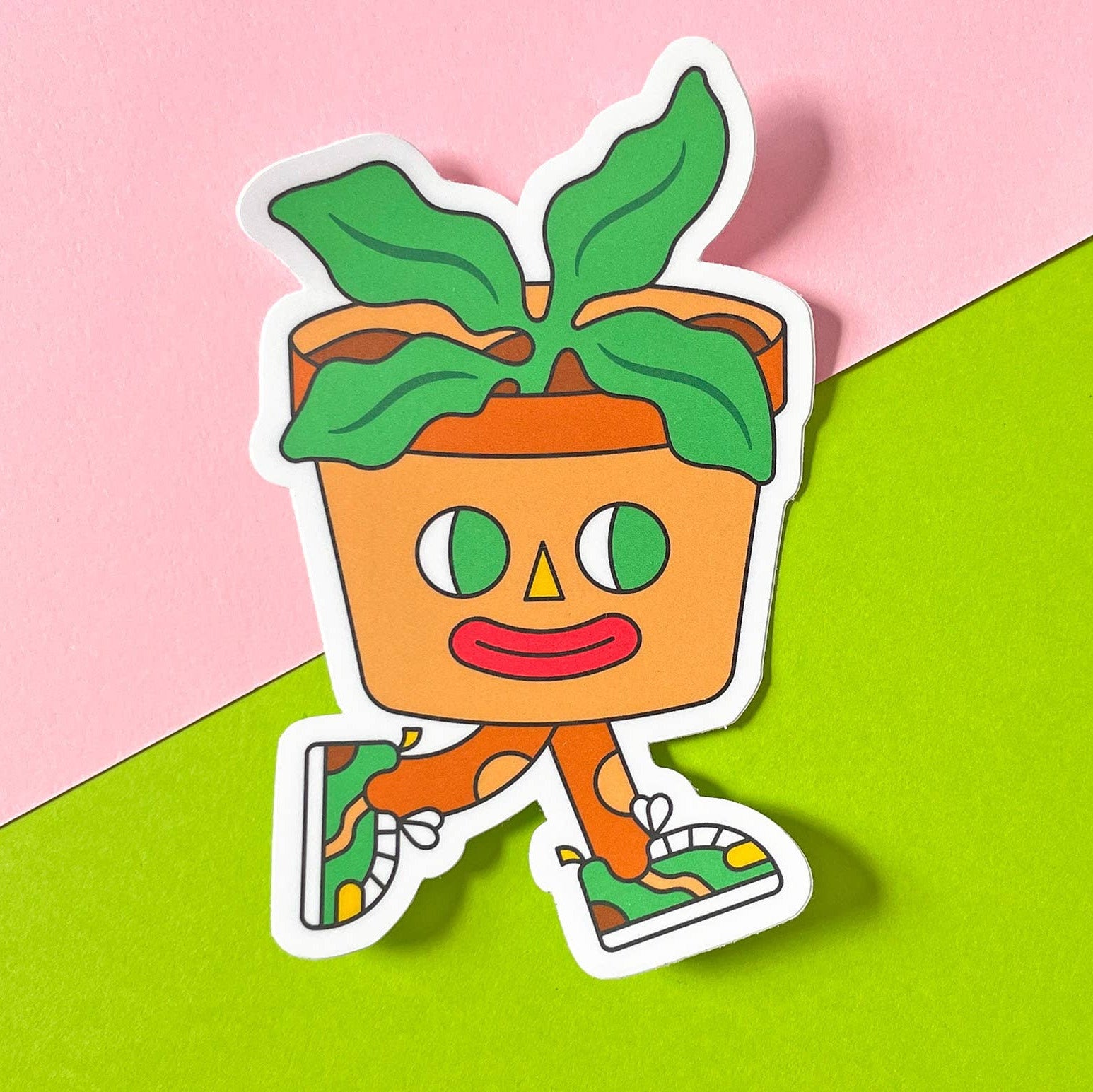 Cartoon character with a pot and leaves on a pink and green background