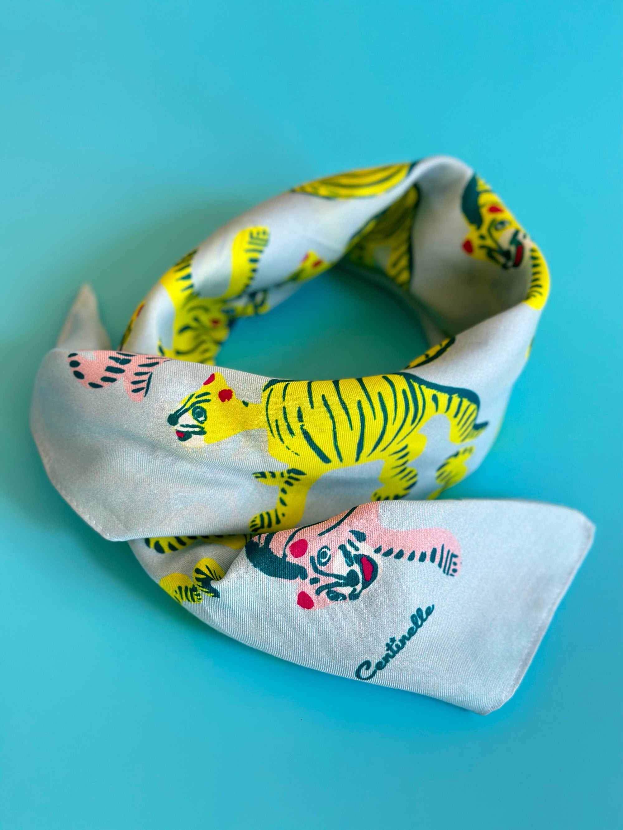 Fabric swatch with tiger design on a blue background