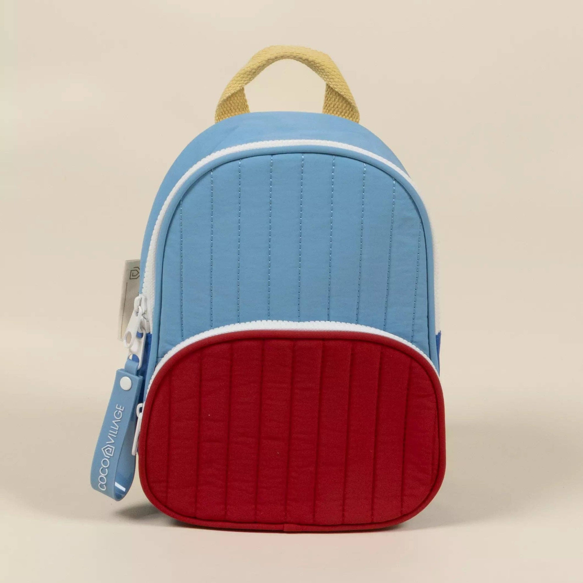 Blue and red quilted backpack on a beige background