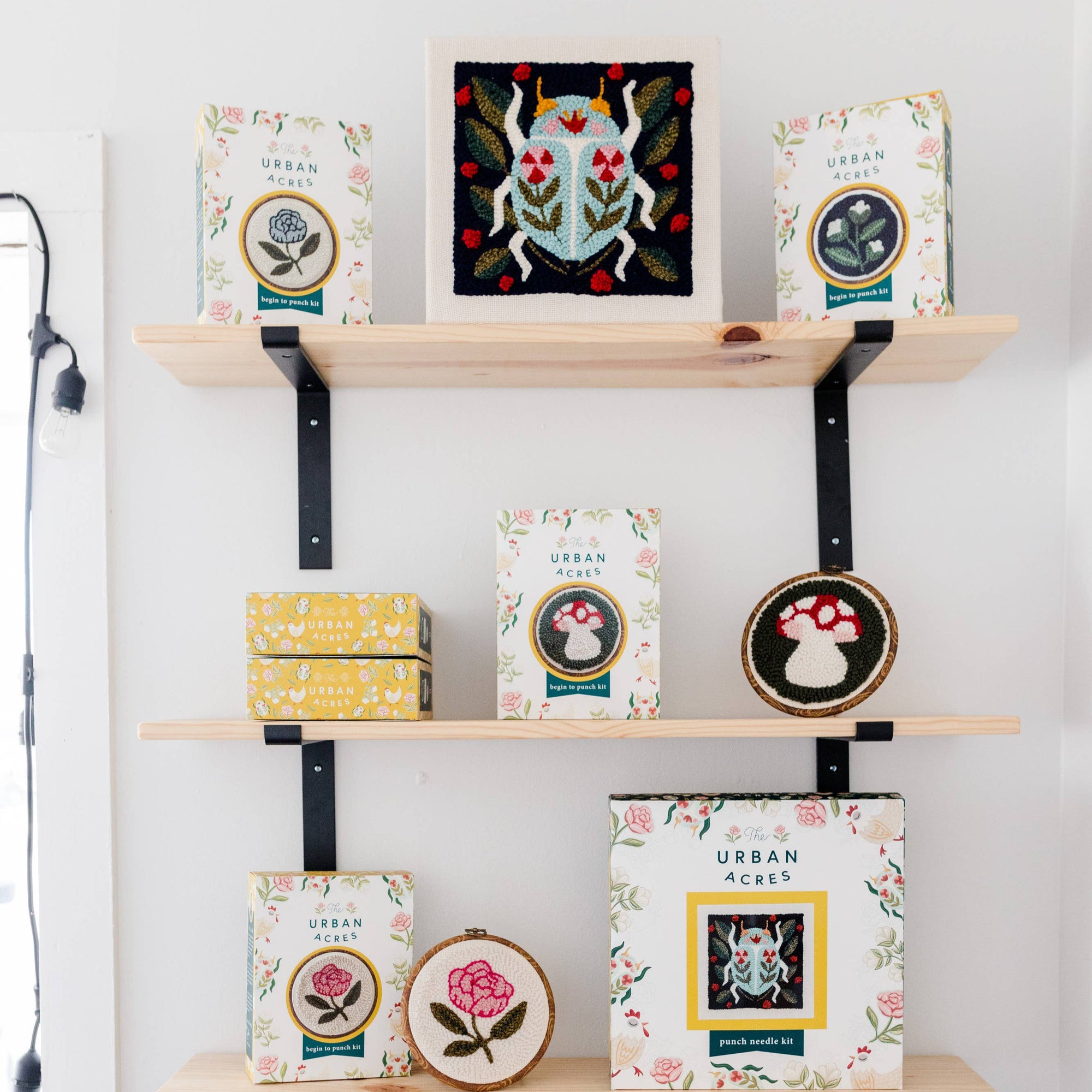 Shelves with decorative boxes and framed artwork against a white wall.