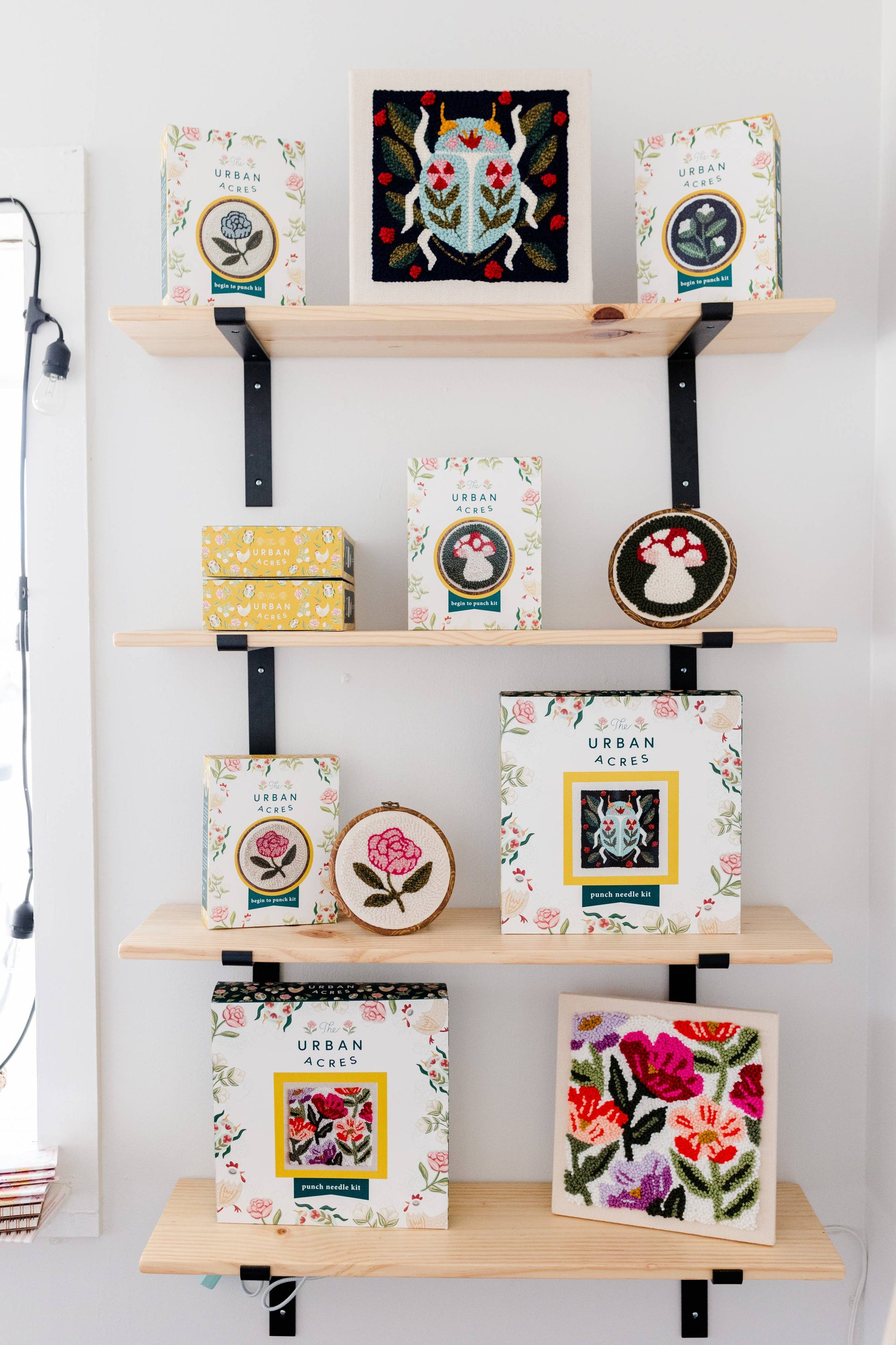 Shelves with decorative boxes and framed artwork against a white wall.