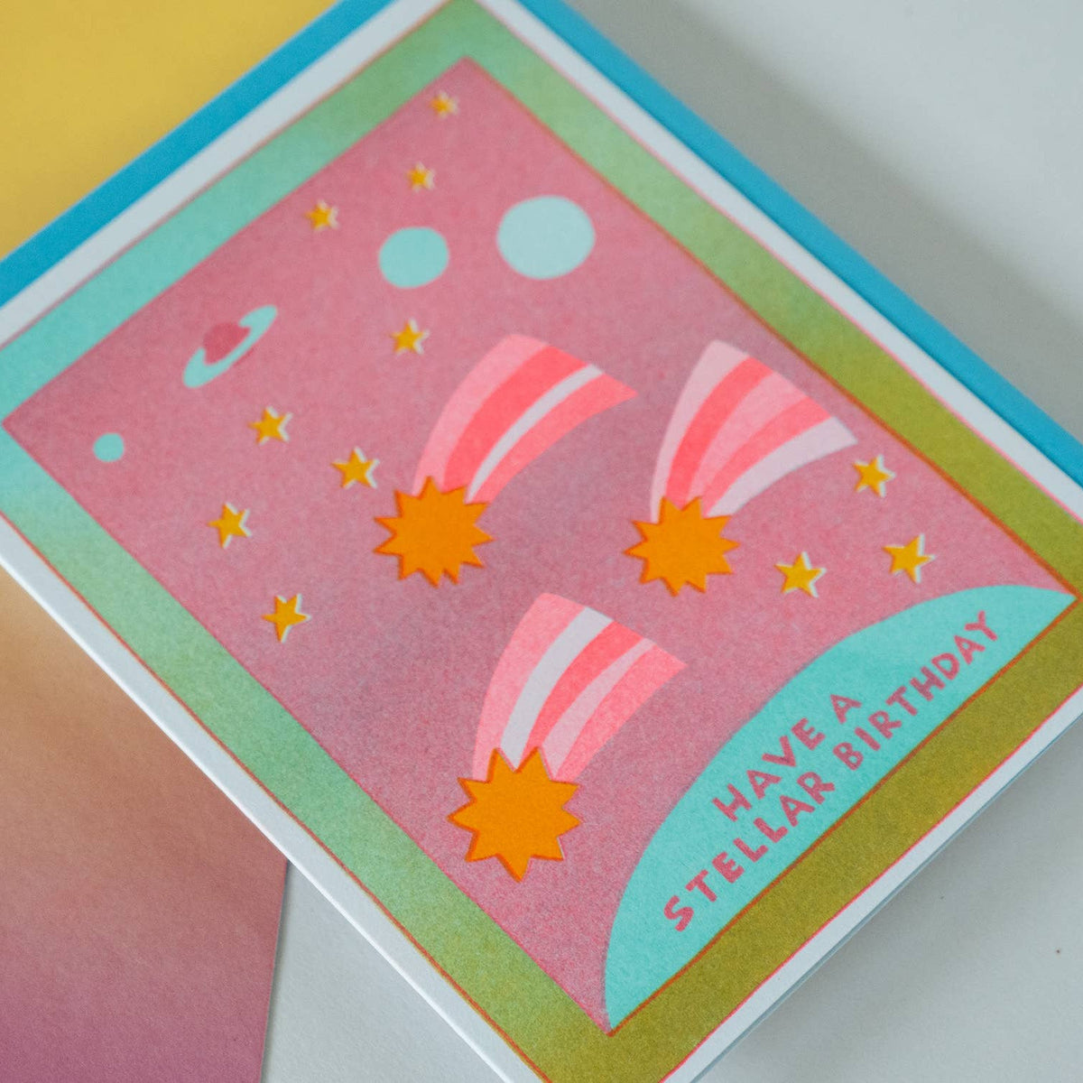 Colorful birthday card with space-themed design and 'Have a Stellar Birthday' text on a gradient background.