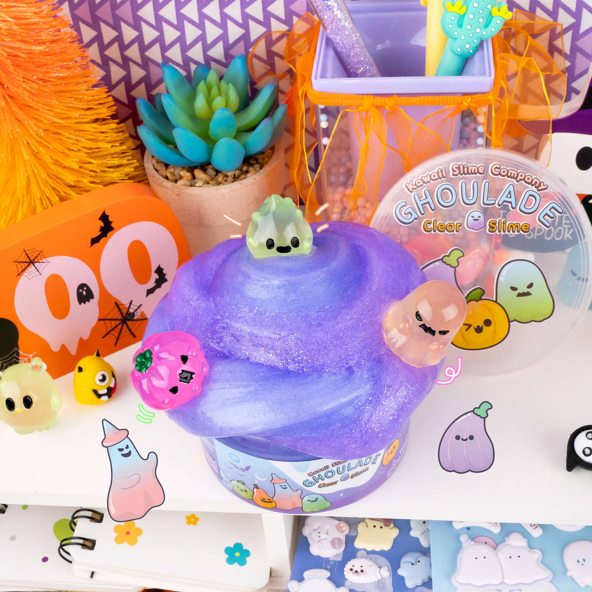 Purple slime with small characters on a colorful background with Halloween-themed decorations.