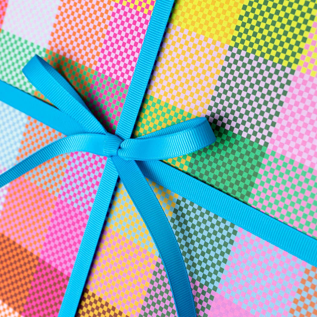 Colorful patterned paper with a blue ribbon tied in a bow
